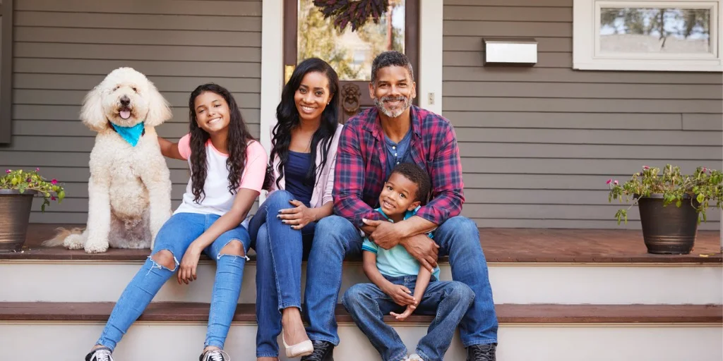 family-with-children-and-pet-dog-sit-on-steps-of-home-picture-id904483216-2.jpg