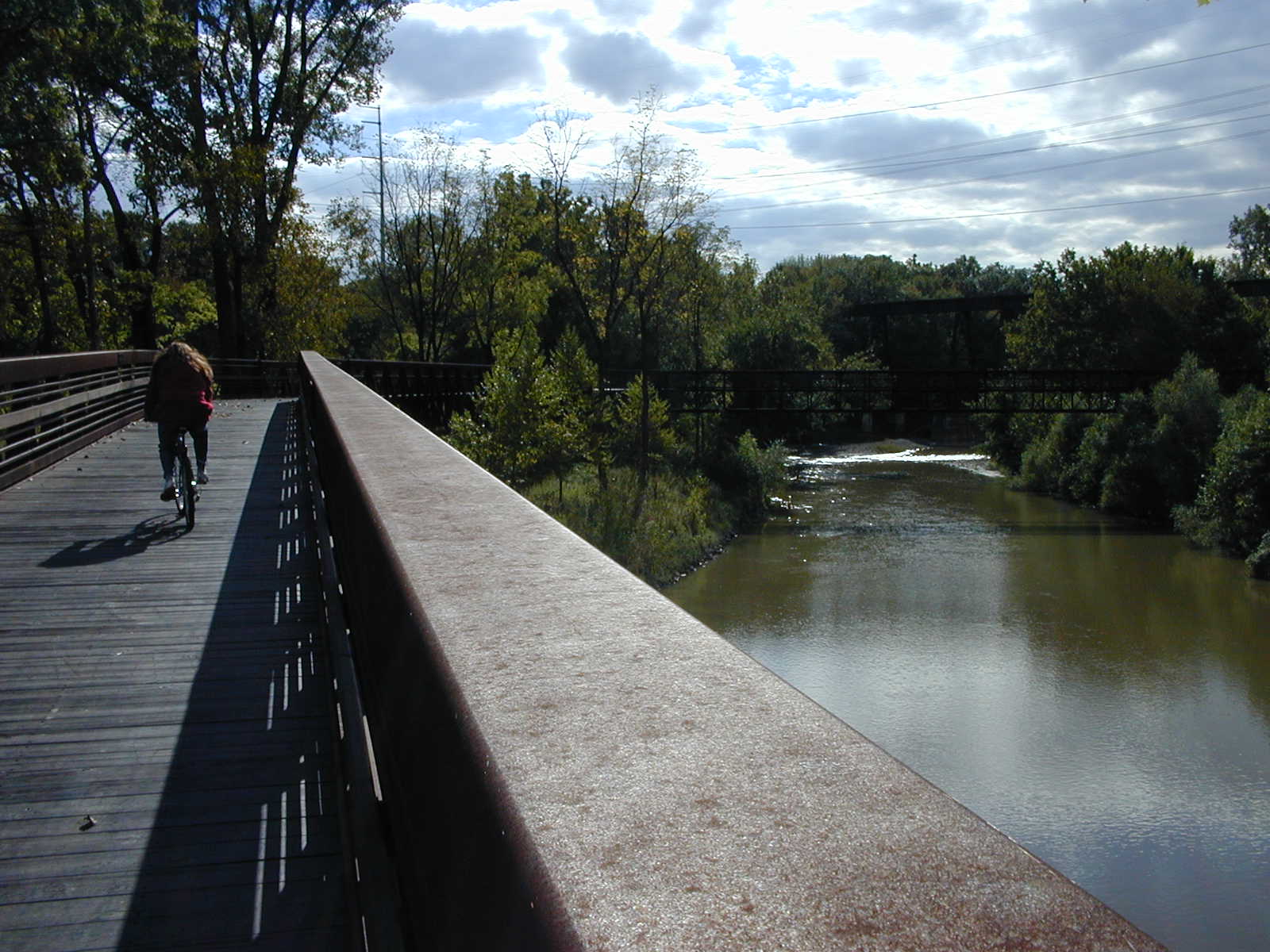 Biker on one of the 1000-foot bridges of the Bridgeway Trail
