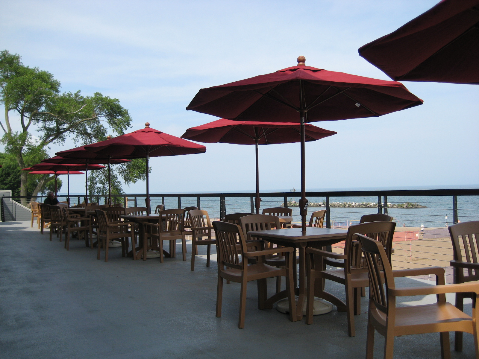 Tables with umbrellas on top of Sunset Terrace at Lakeview's back balcony