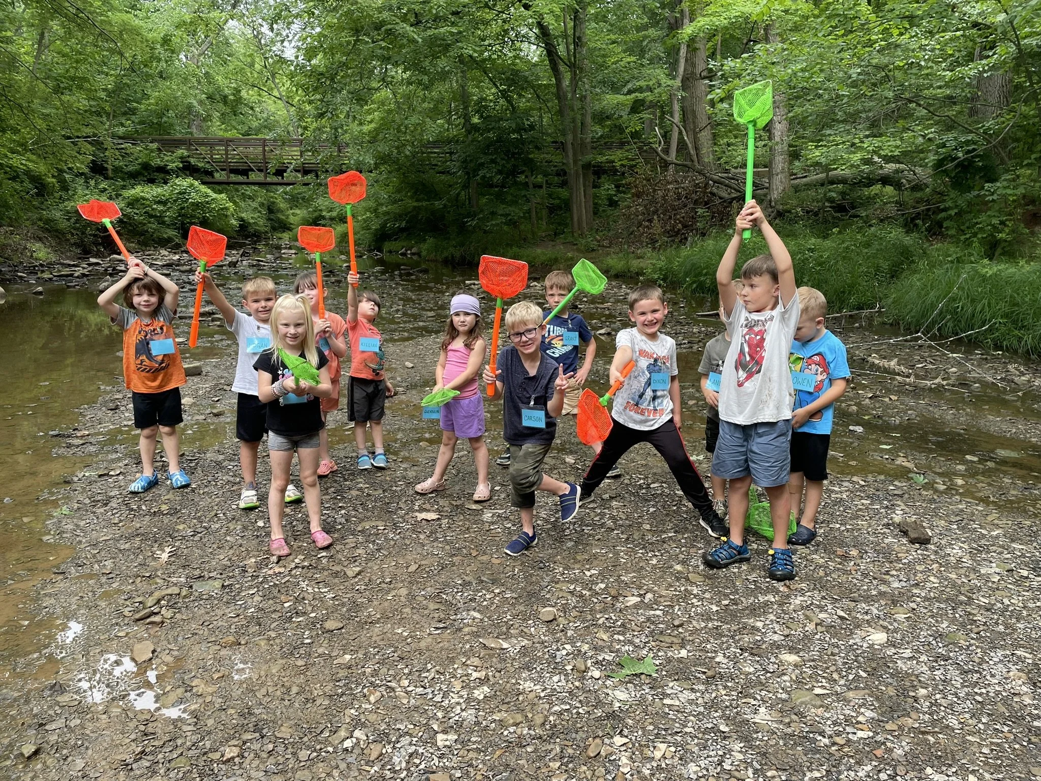 Campers exploring a river habitat