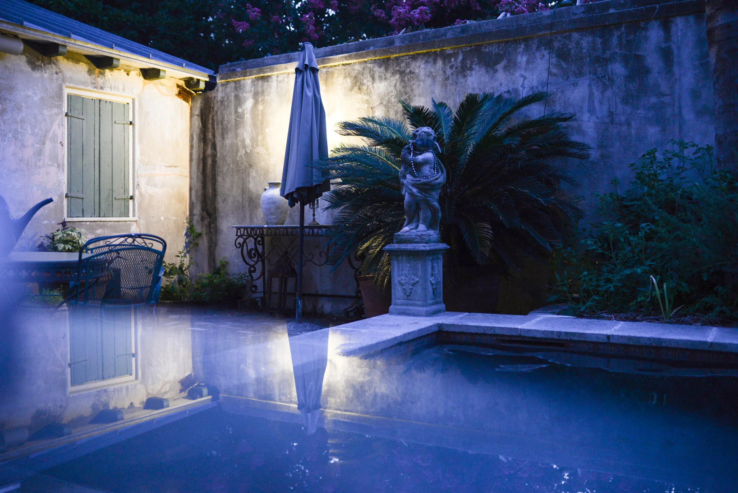 a french quarter courtyard at dawn
