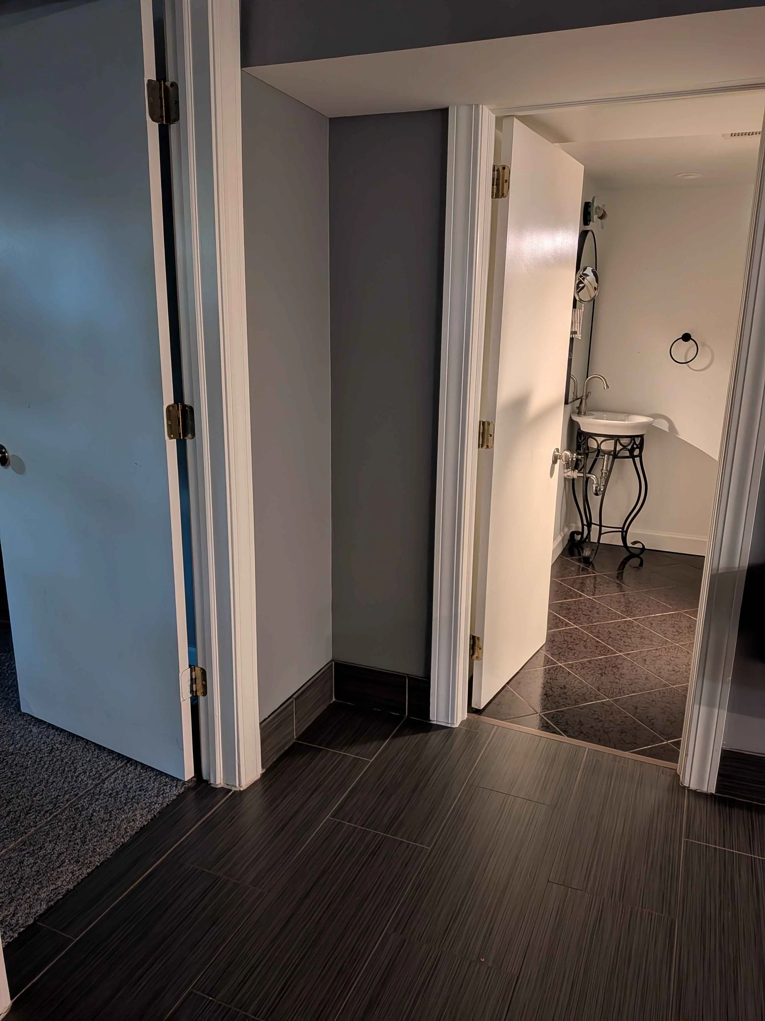 Two open doorways, one into a bedroom and one into the bathroom.