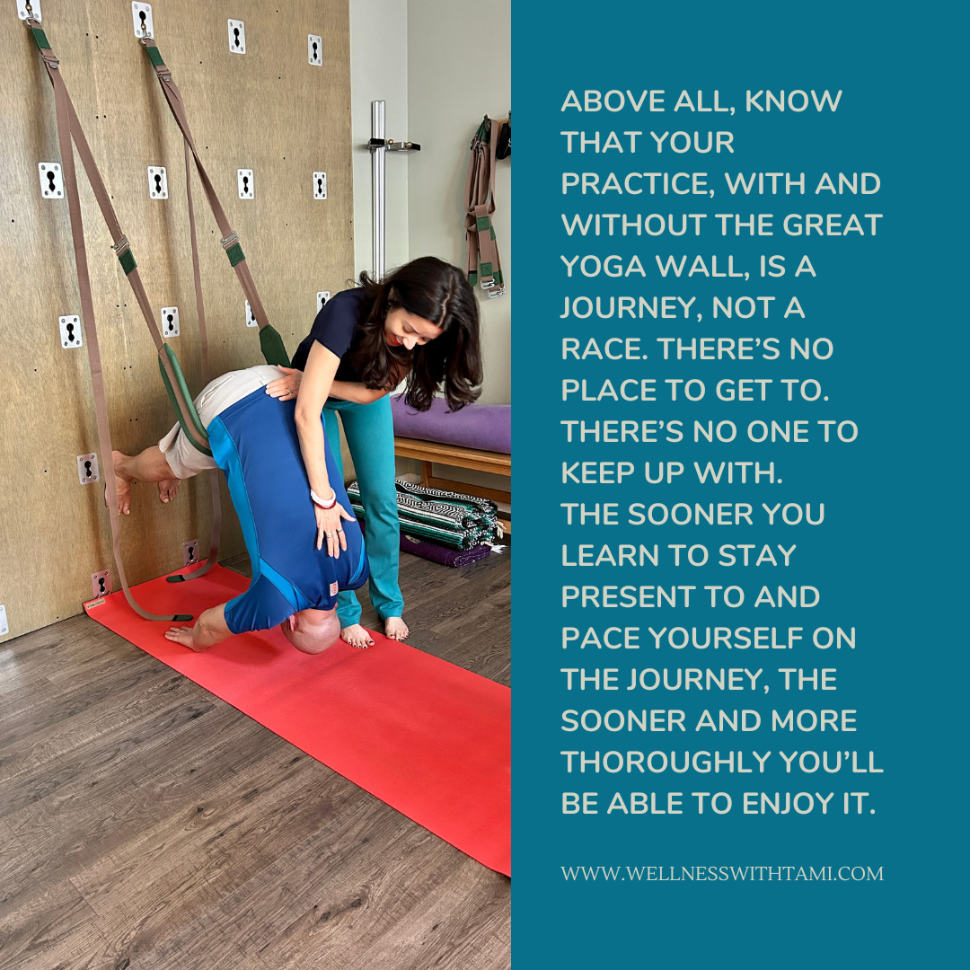 Teal quote card with photo of man hanging in Extended Forward Bend on the Great Yoga Wall and woman with hands on his back and quote, "