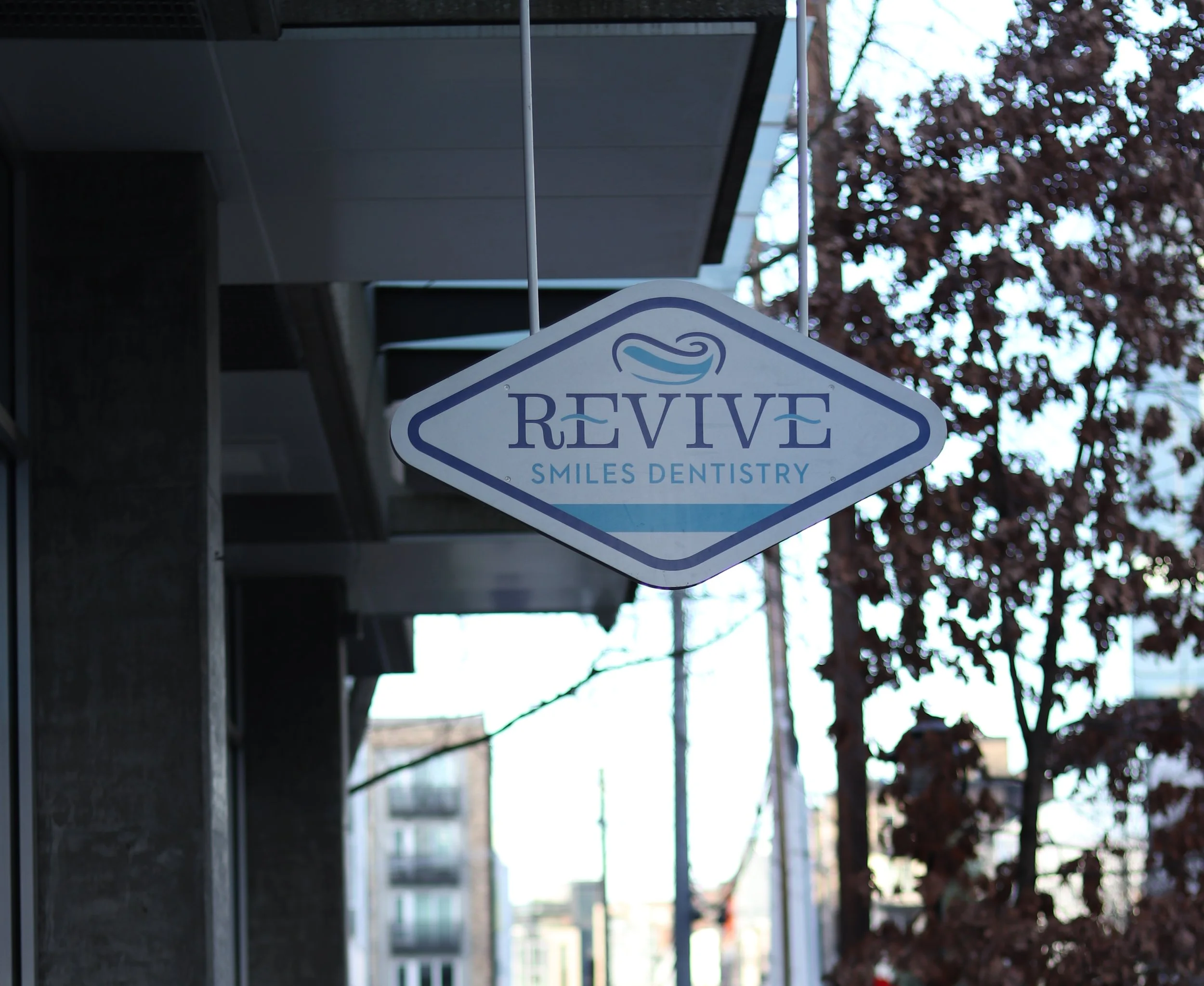 Exterior sign outside of Revive Smiles Dentistry in Seattle, Washington