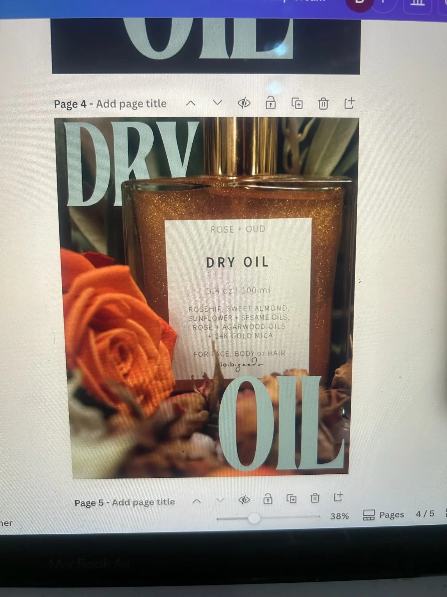 A close-up photograph of a golden bottle labeled 'Rose + Oud Dry Oil' with orange roses and other flowers around it, and blurred text and decorative elements in the background.