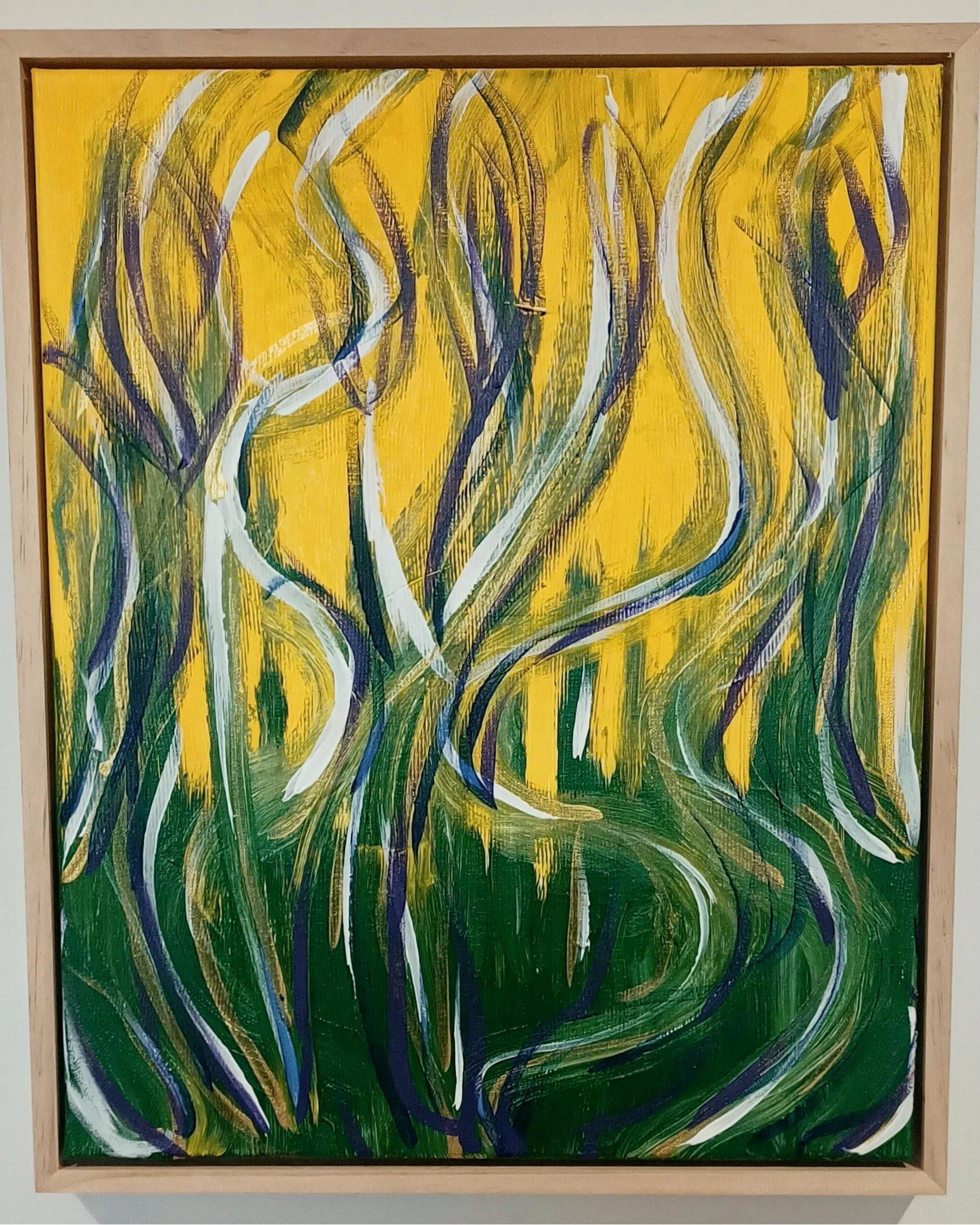 In Bloom — $350. Acrylic on canvas, framed 43 × 53cm. A meadow in full growth - grass and flowers across a vivid yellow ground, hints of violet and blue.