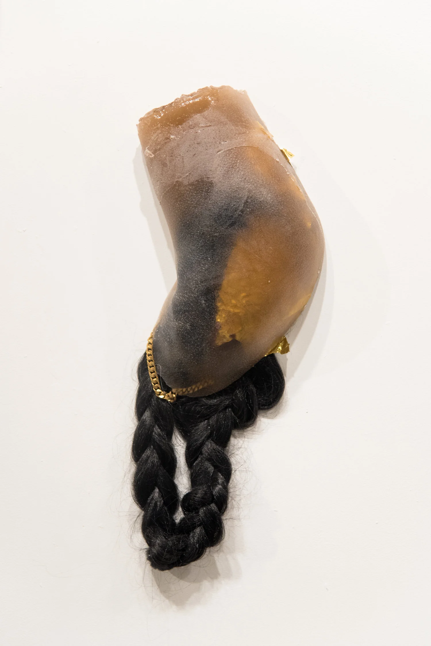 99 Holds , Indoor rock-climbing wall made from 99 unique poured dyed resin casts of the corners of the artist's body. Embedded with wearable Cuban chains, hair, and hypothermia blankets, 120 × 297 in, 2017