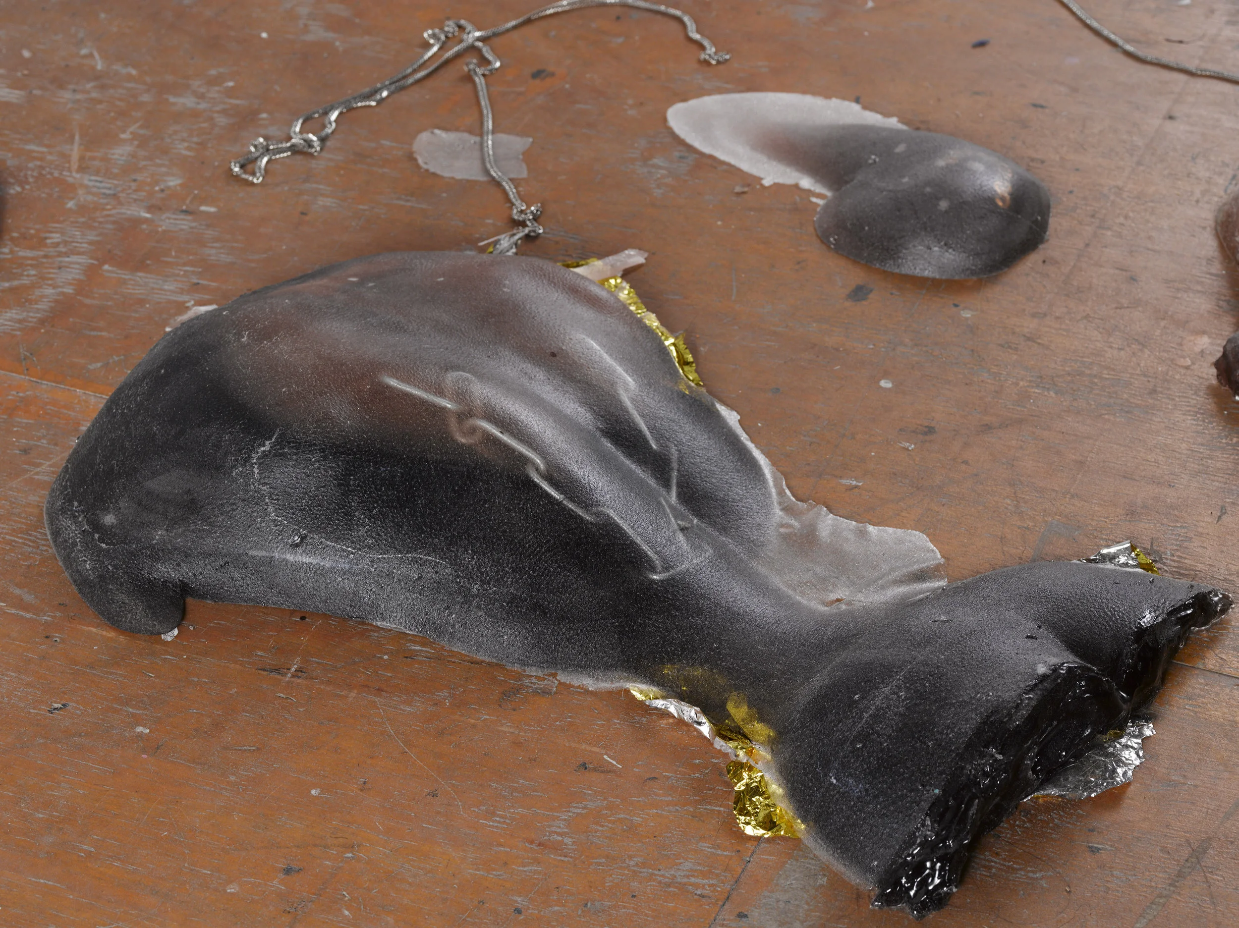 99 Holds , Indoor rock-climbing wall made from 99 unique poured dyed resin casts of the corners of the artist's body. Embedded with wearable Cuban chains, hair, and hypothermia blankets, 120 × 297 in, 2017