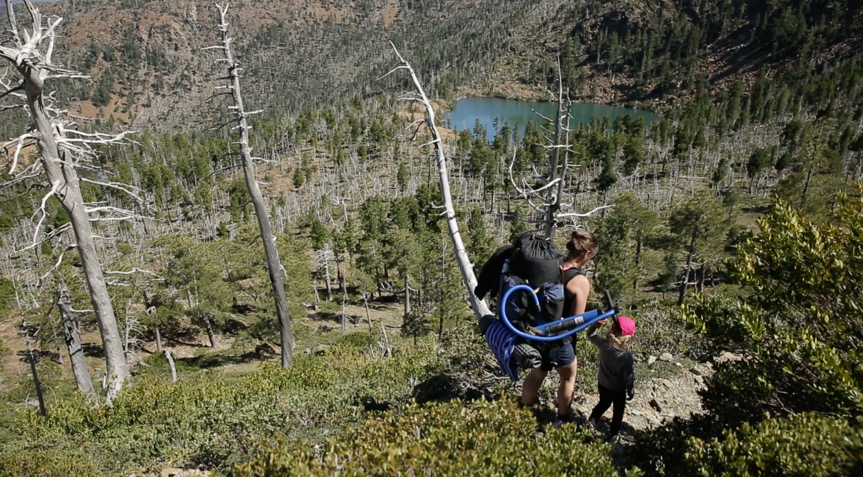 Jill Stokes hikes with her daughter Azalea to a secluded lake.