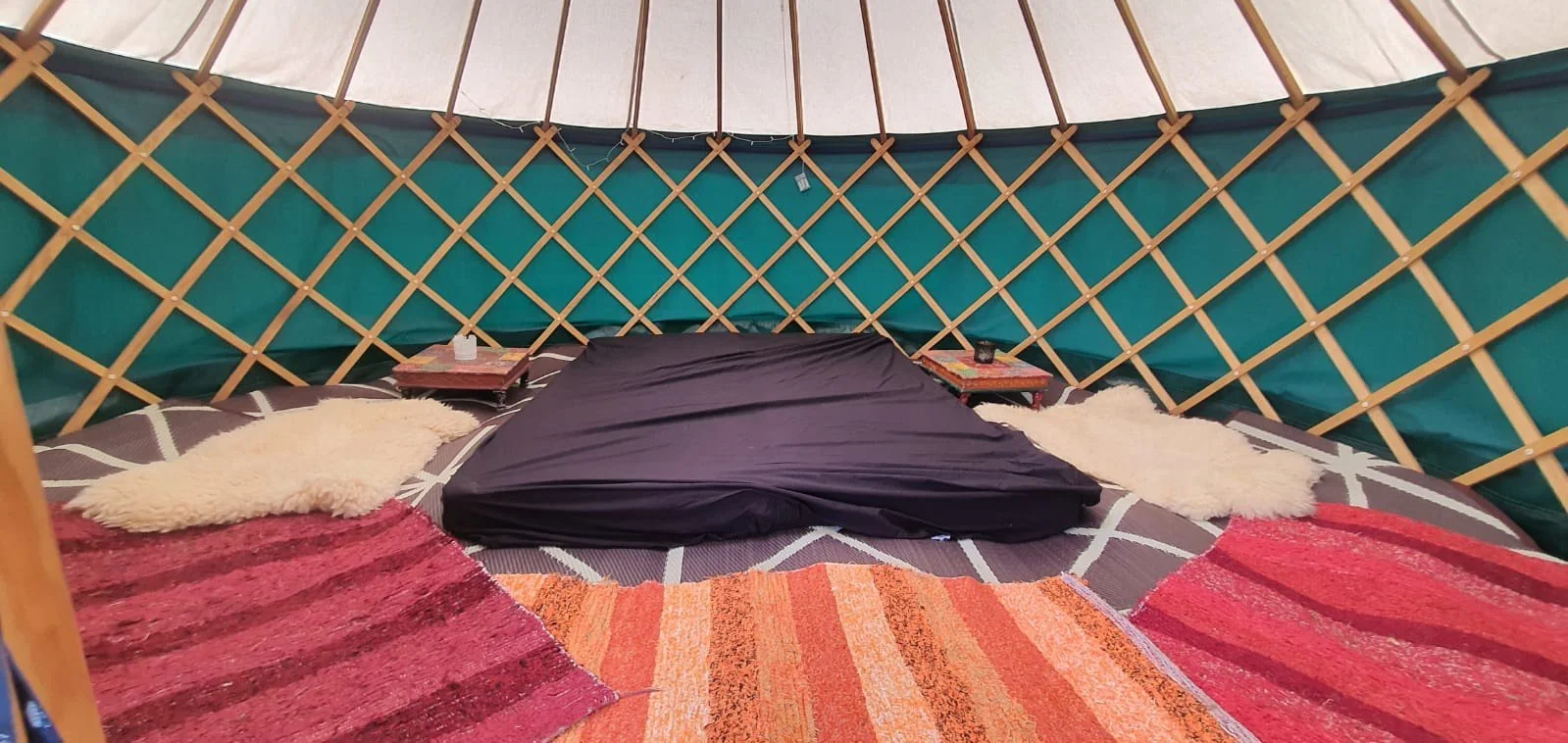 Family yurt rental with twin beds - perfect festival glamping accommodation with traditional decor and comfortable bedding for your event
