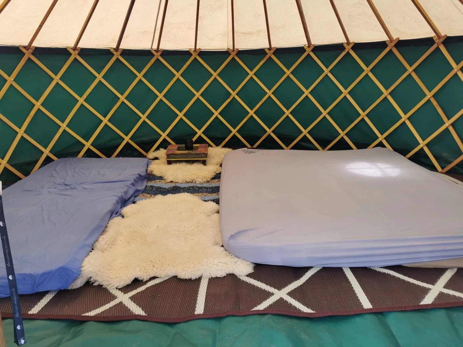Family yurt rental with twin beds - perfect festival glamping accommodation with traditional decor and comfortable bedding for your event