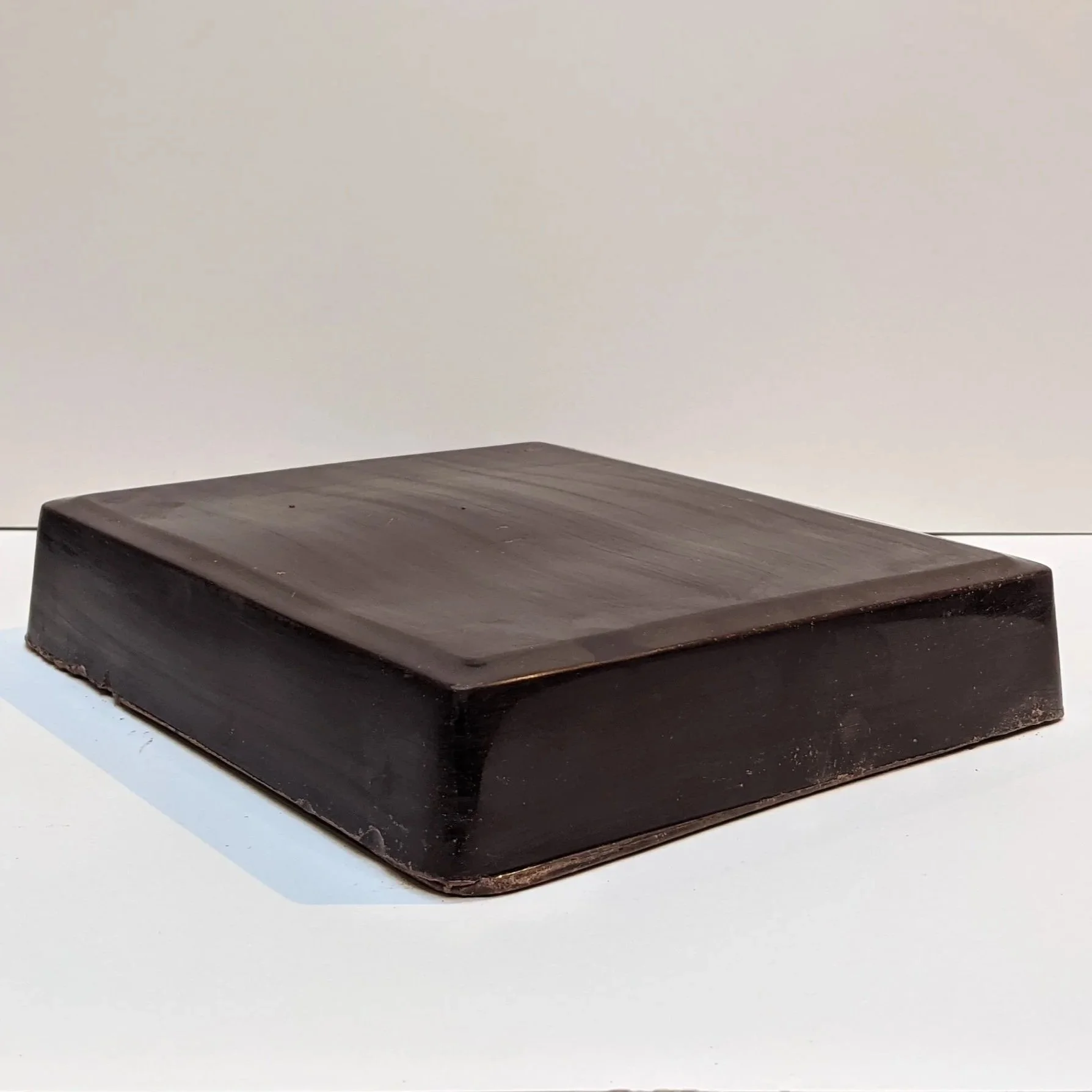 Large ceremonial grade cacao block on surface for preparation
