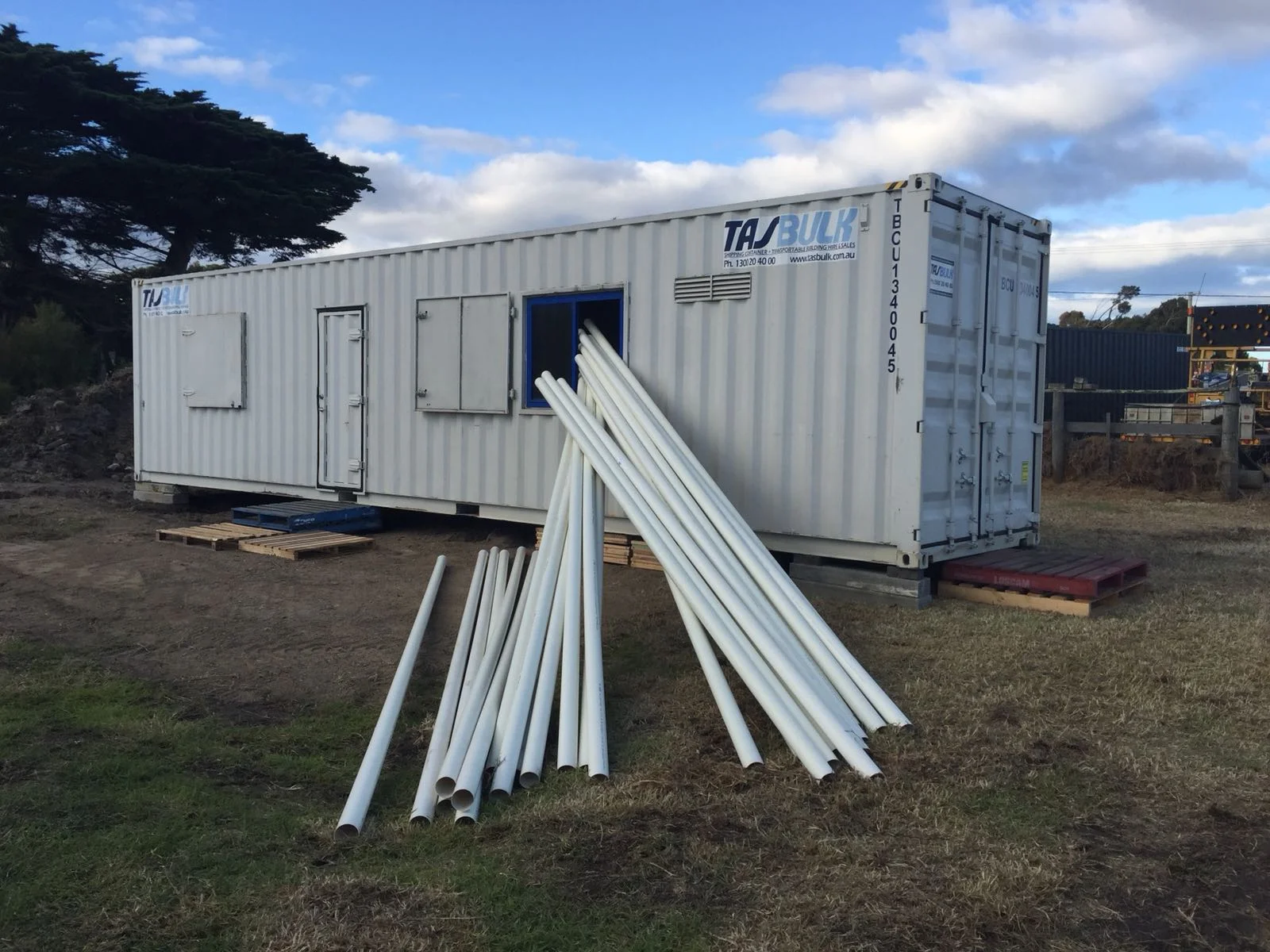 Container placed onto Hatchery site - unloding PVC piping