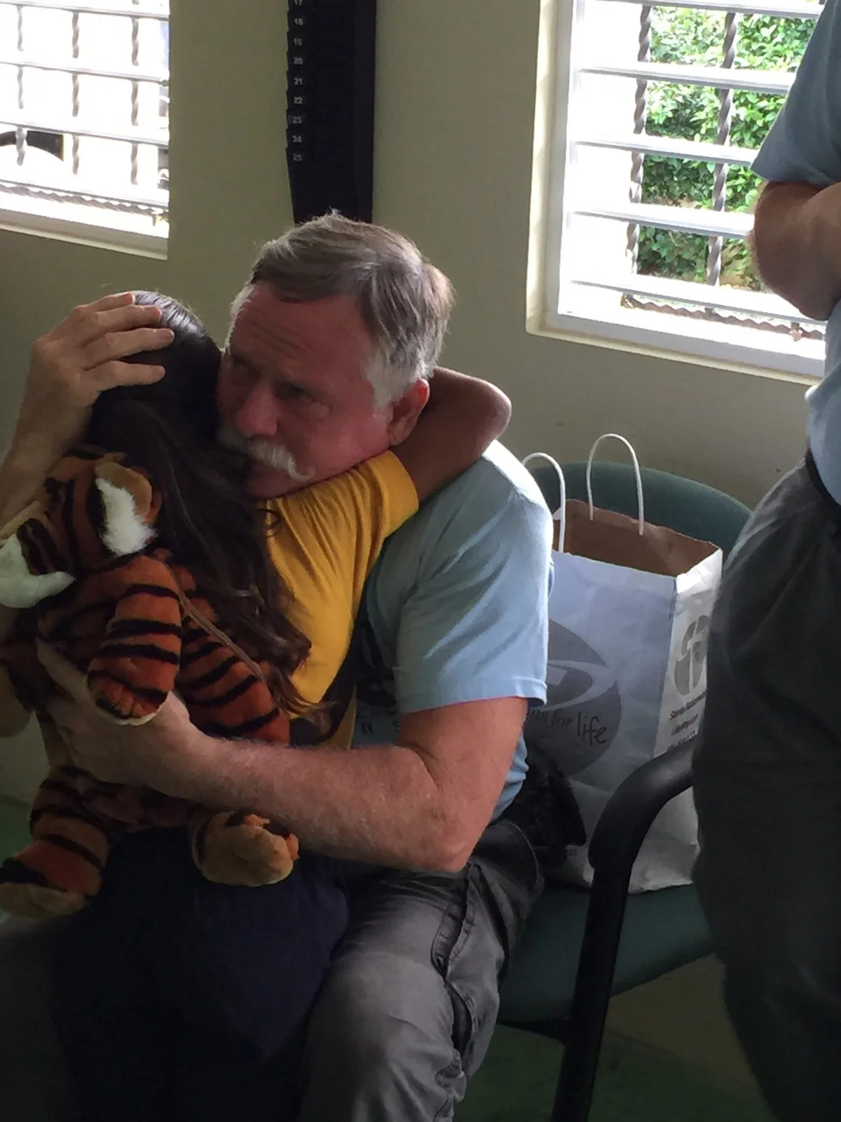 Al_hugging_child_web.jpg