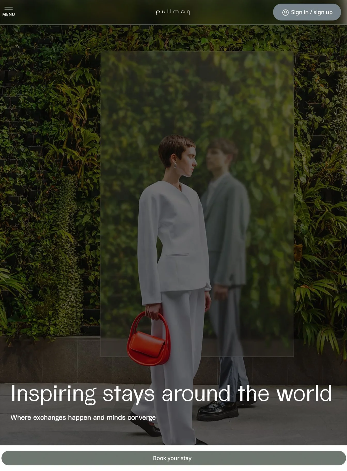 Man and woman standing in front of a hedgerow