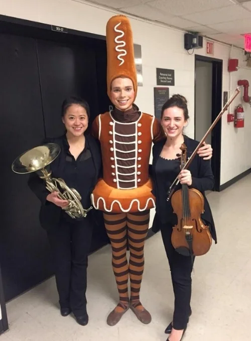 Second hornist Wei-Ping Chou and principal violist Ally Goodman pose with a Gingerbread Man from ABT's production of "Whipped Cream"