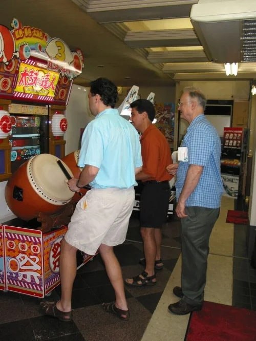  Bass section playing a drumming game at a Japanese arcade in Shinjuku