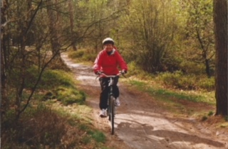 Photo of Meg biking in the forest -- Netherlands
