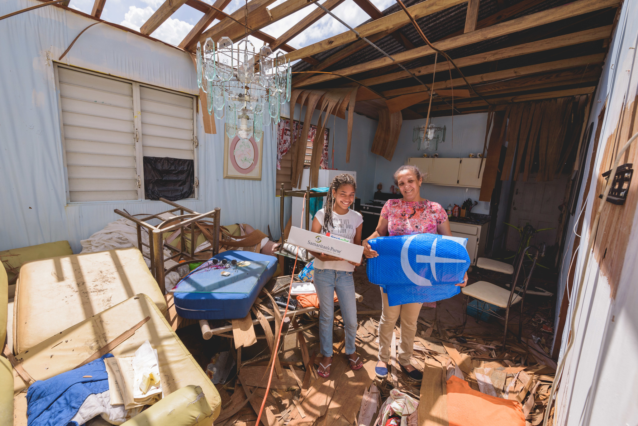 Barrio Obrero, Puerto Rico - Juana Reyez (right) and her niece Wilmarie, were in Juana’s home when the hurricane hit. The roof collapsed on top of Juana during the storm, but she was uninjured. She was especially grateful for the relief supplies since she had no money, food, power or water.