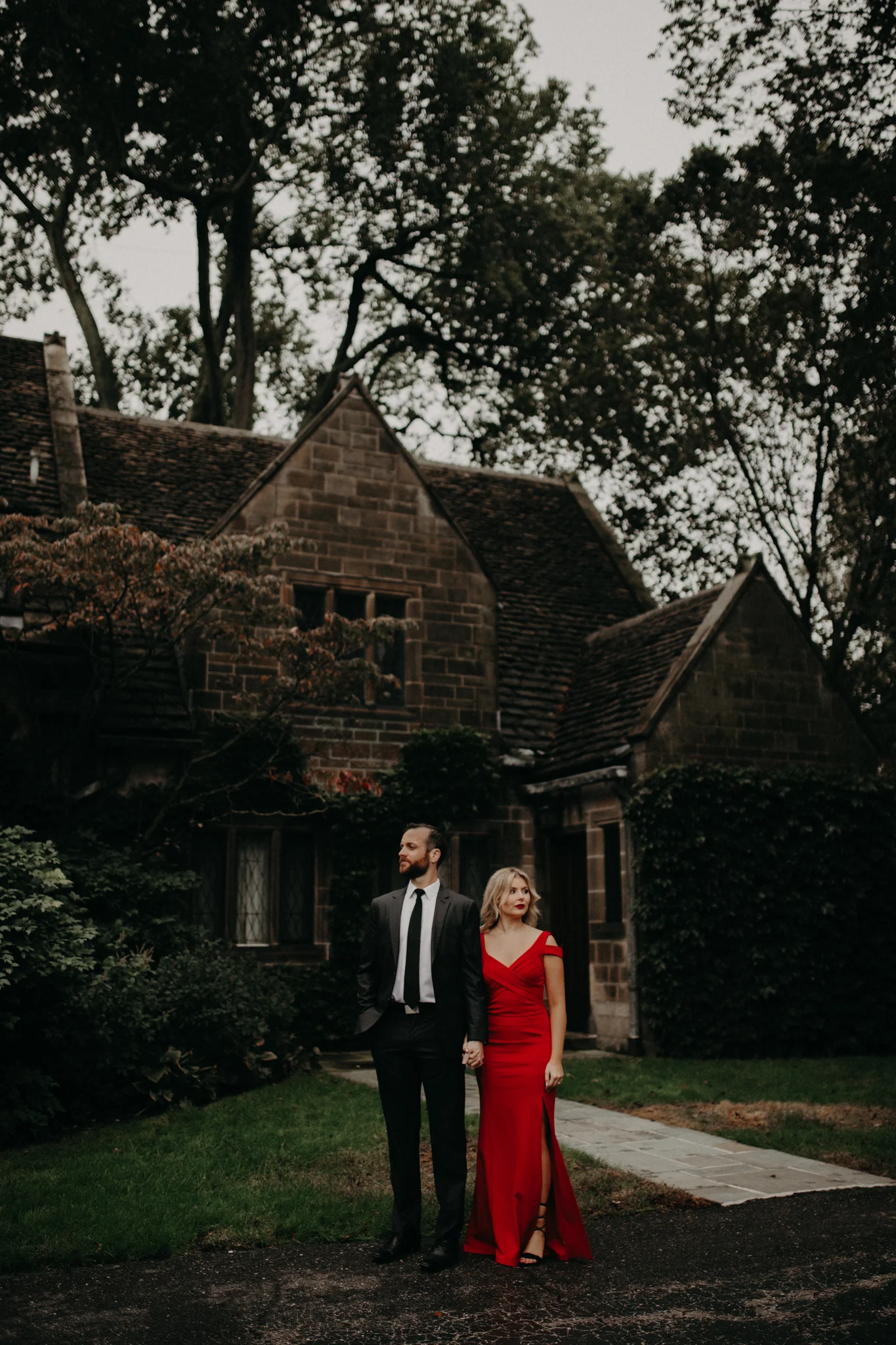 Couple wearing red dress standing at Edsel & Eleanor Ford Mansion