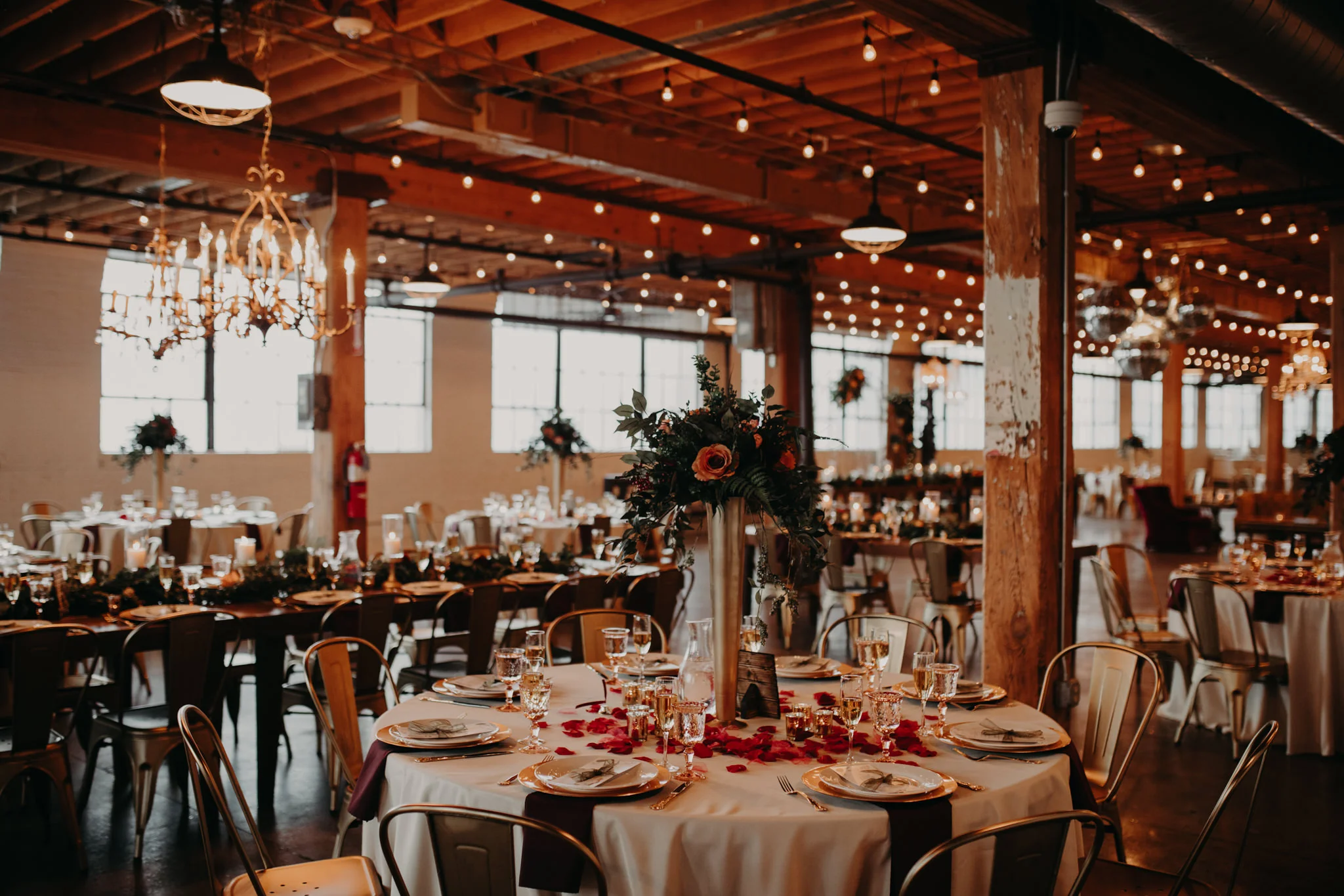 Table and plates set up with lights and greenery at The Cheney Place