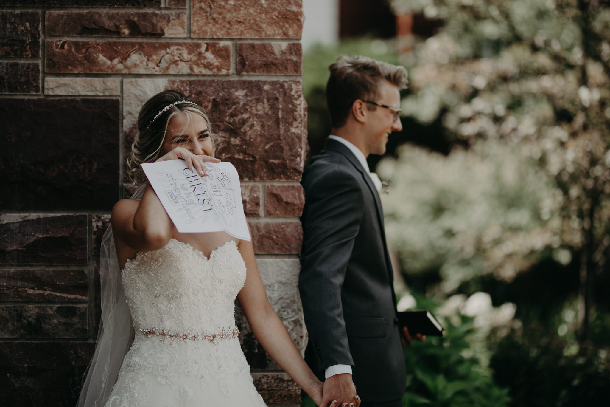 Bride and groom reading letters at St. Peter Cathedral in Marquette
