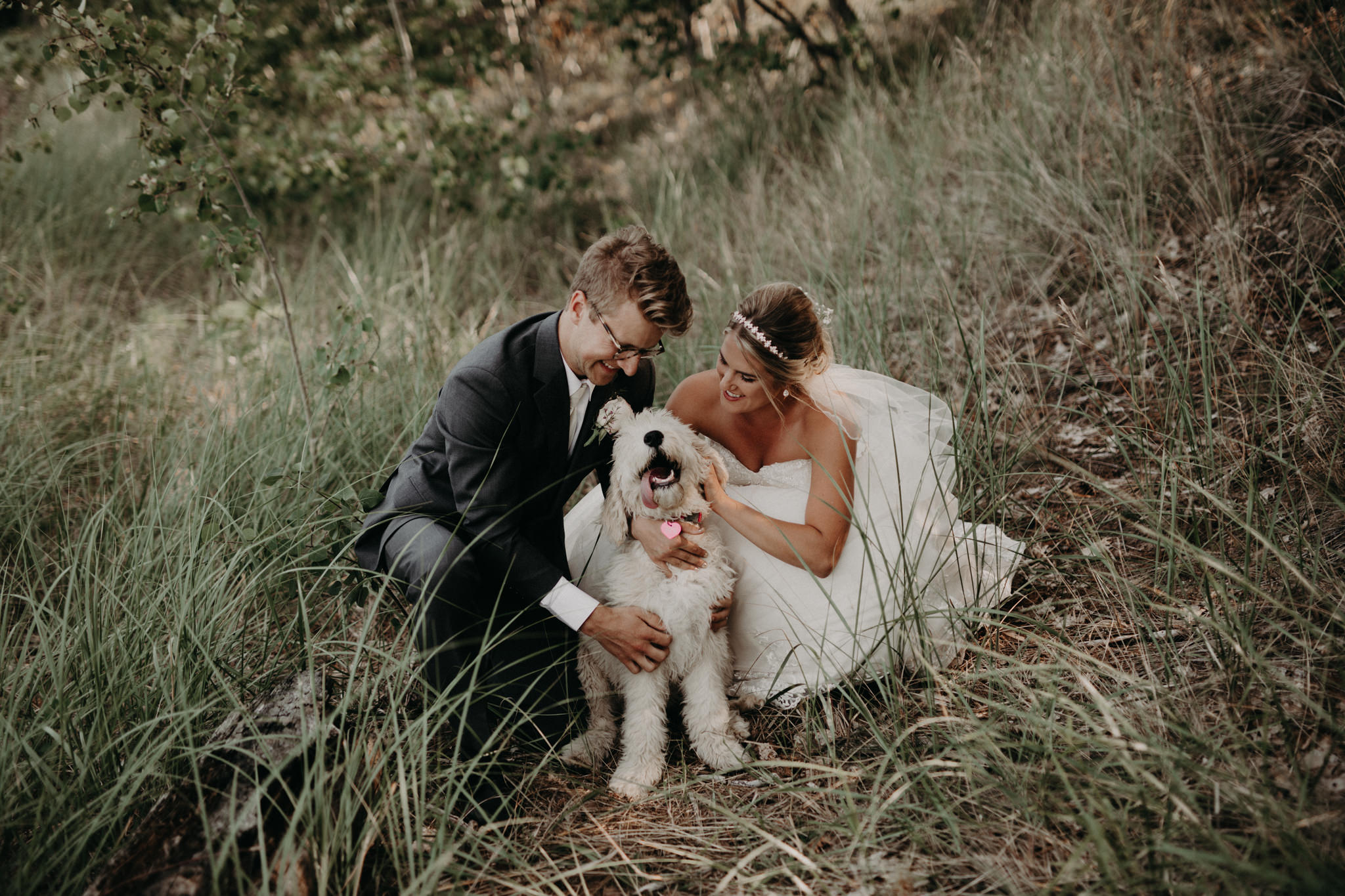 Bride and groom with Goldendoodle at McCarty's Cove