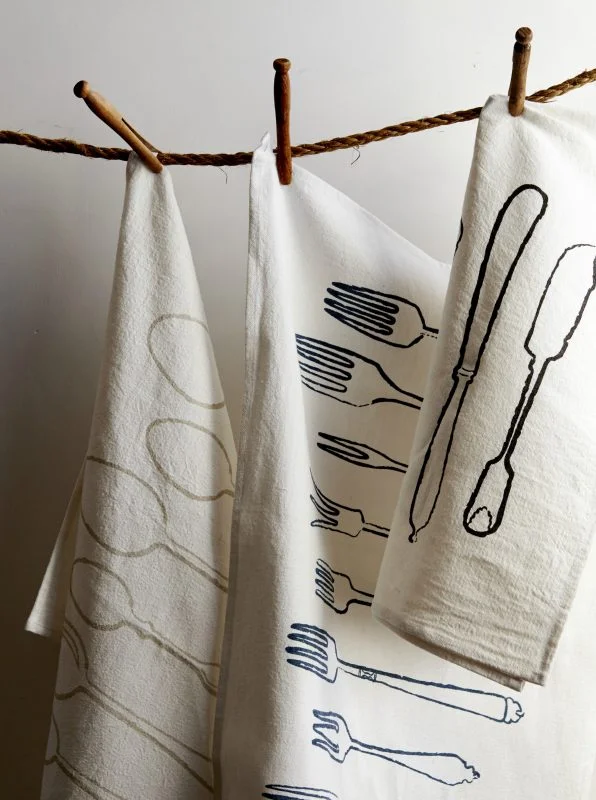 We have numerous handprinted cotton and linen tea towels including our favourite, Utensils.