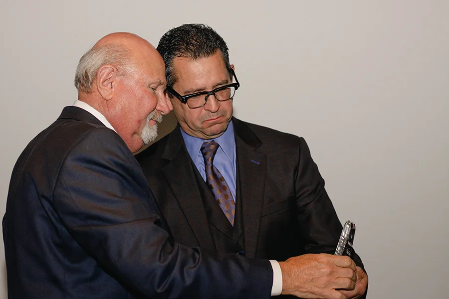 Fletcher Handley receiving the Trial Lawyer of the Year award, courtesy of High Five Media