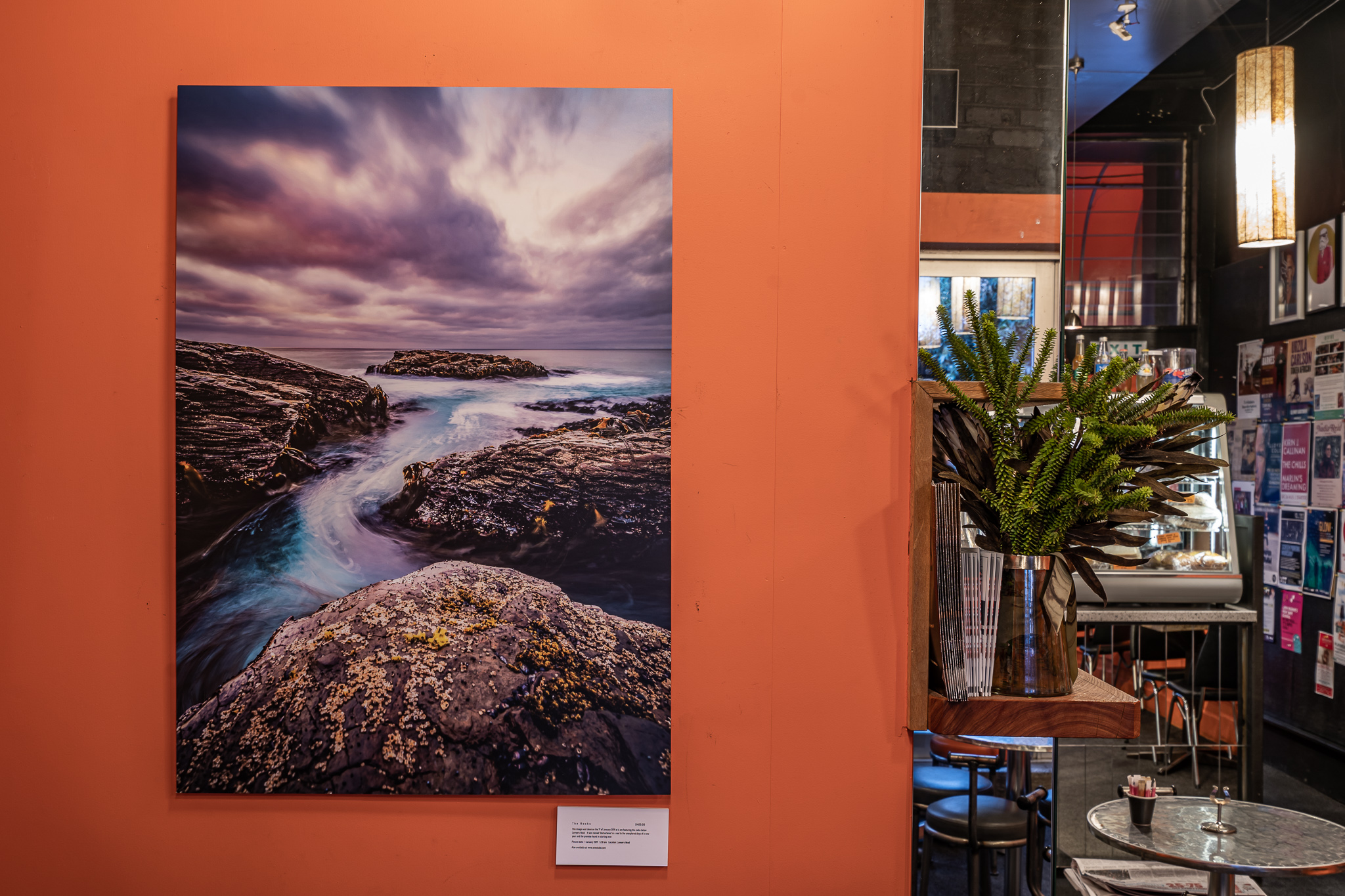 Ocean and rocks Dunedin print in cafe exhibition