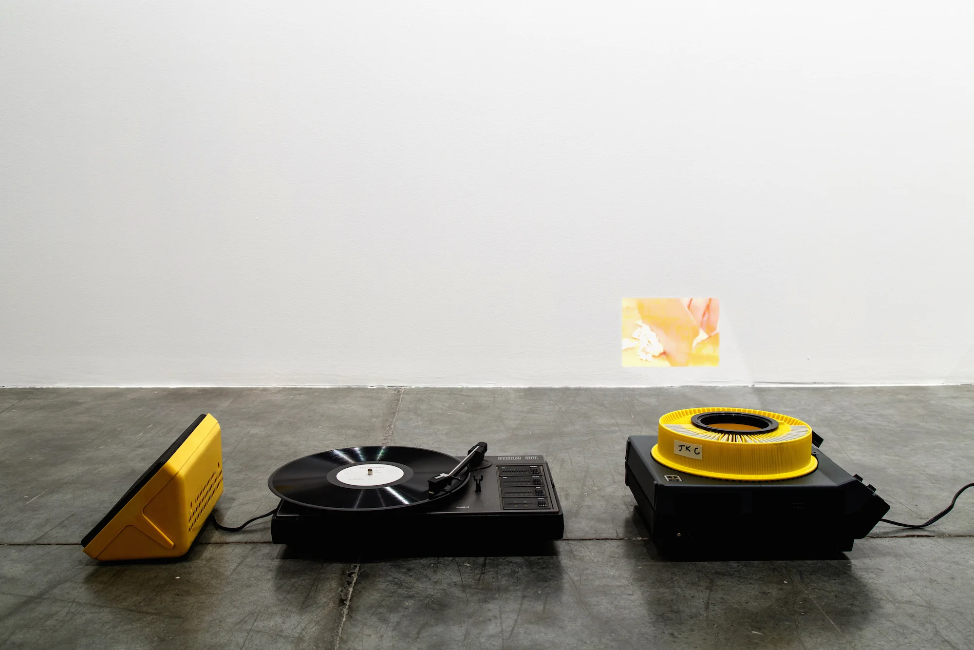 Yan Can Cook 2015 Turntable, vinyl record with locked groove, carousel slide projector, 35mm slides Dimensions variable Variation of 2 + 1 AP