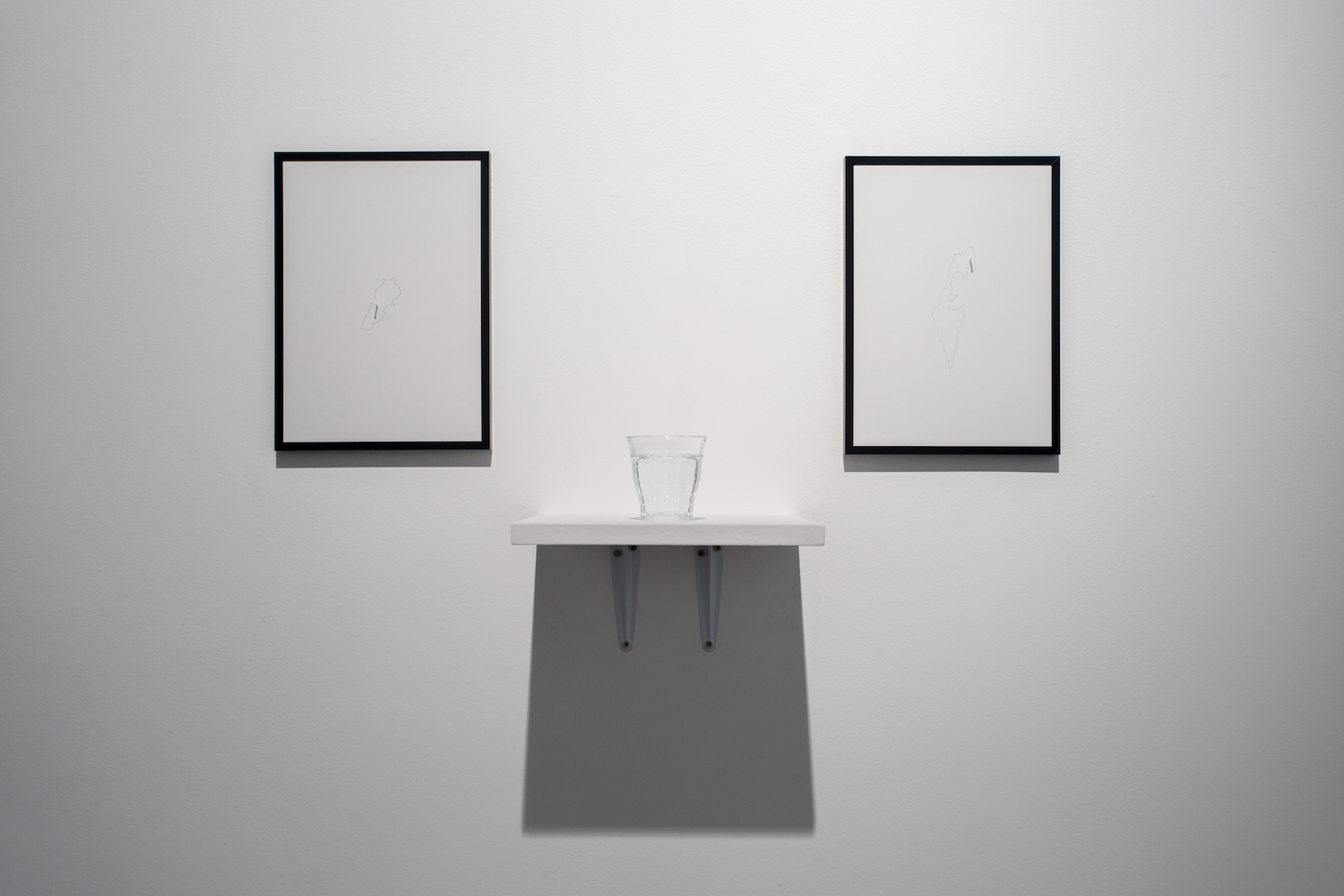  Charbel-joseph H. Boutros  Mixed Water, Lebanon, Israel 2013 Glass of water, an equal mix of Lebanese mineral water (Sohat) and Israeli mineral water (Eden), wooden shelf, inkjet print on recycled paper, painted nails Dimensions variable Edition 1/3