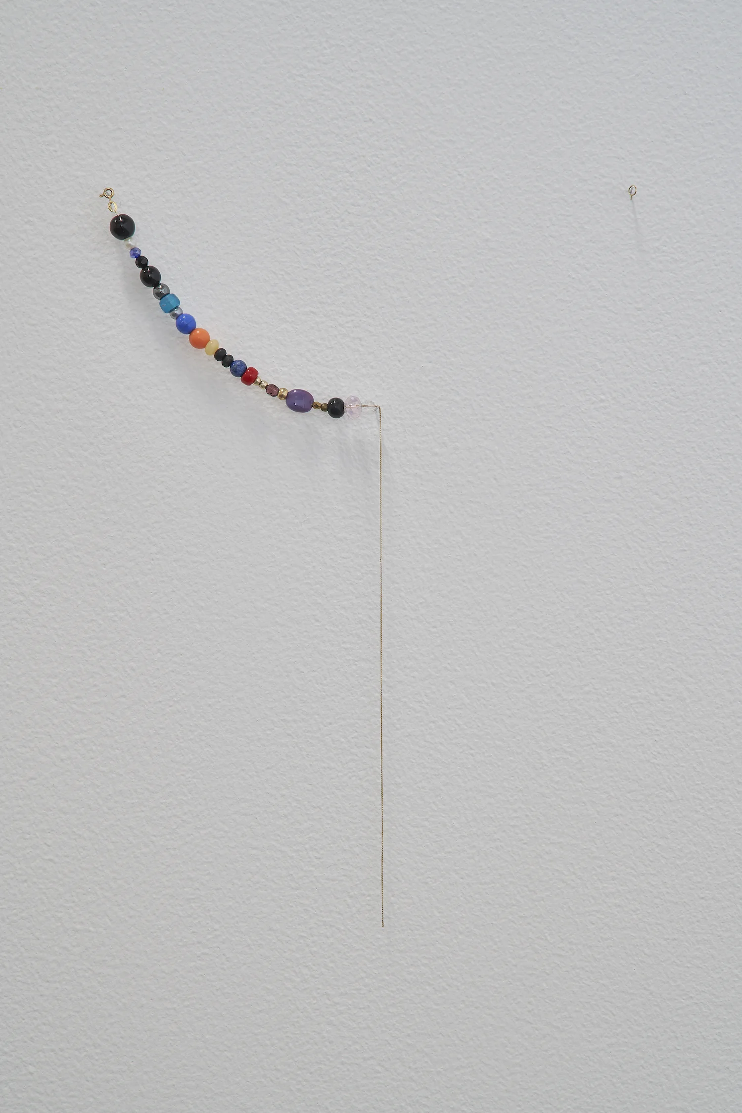 A Necklace of Found Beads 2014 - 2019 18-carat gold chain, 25 found beads Dimensions variable A necklace is composed of beads found by chance by the artist between 2014 and 2019. Left open, it will complete once the number of beads matches the age of the artist.