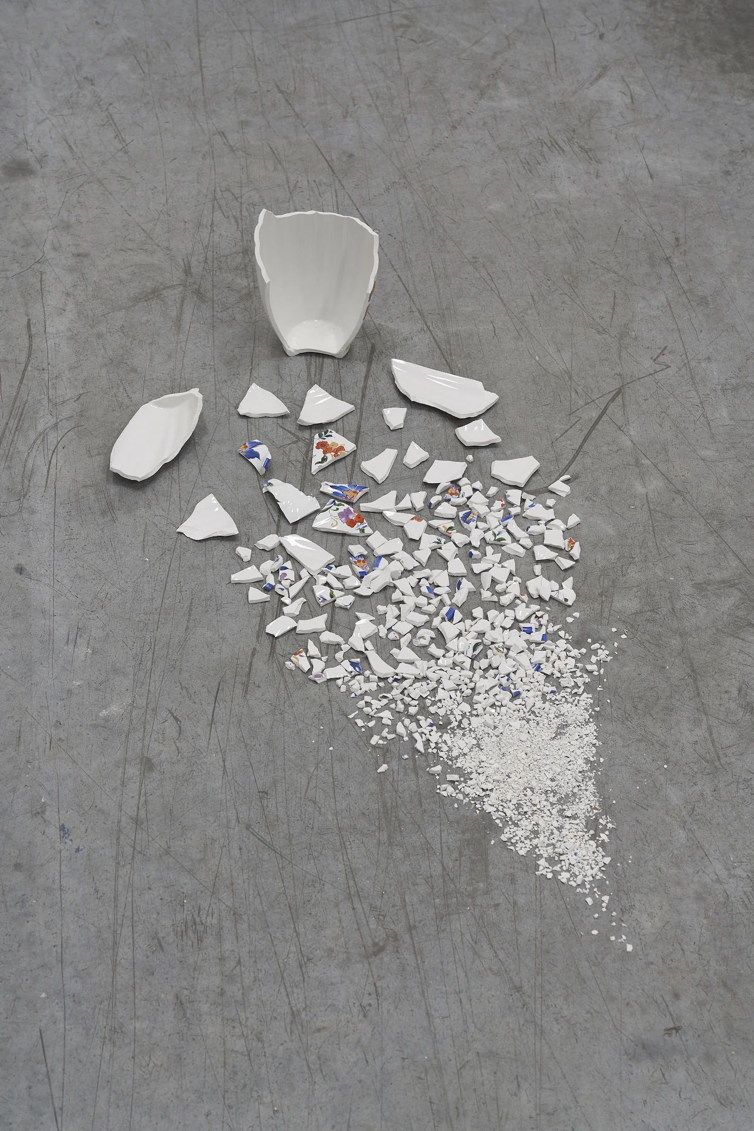 Accelerated Time 2014 Vase broken in fragments size of installation: 50cm long A vase is broken into smaller and smaller fragments, until some of its fragments are reduced to powder.