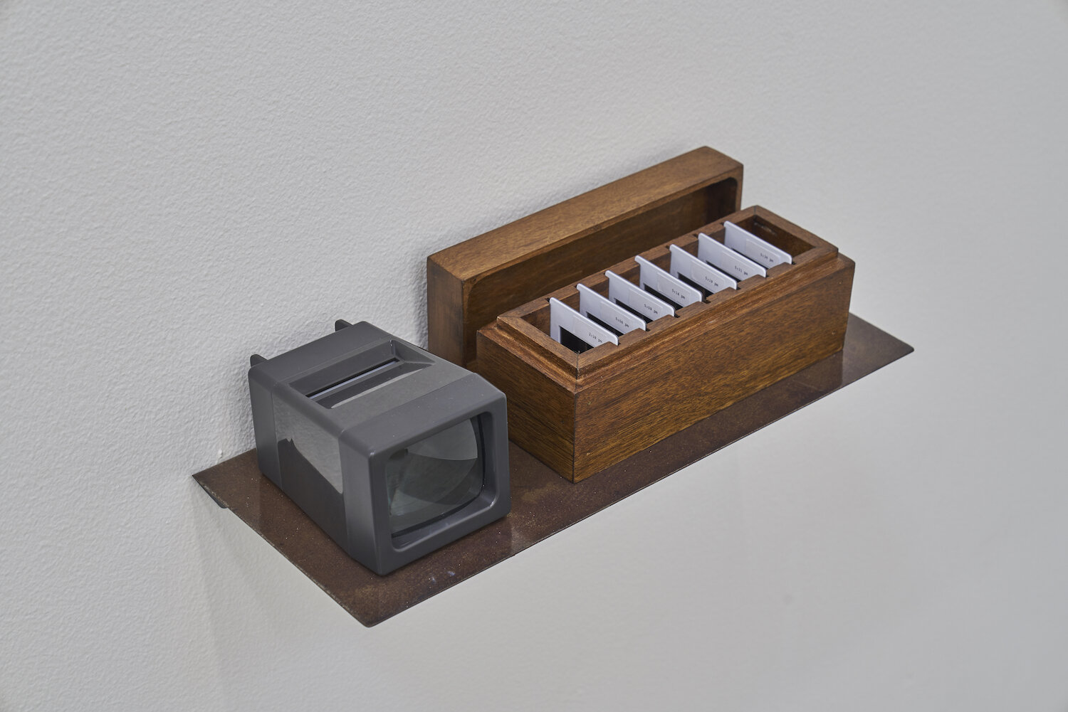The Clay Files 2019 Seven 35 mm slides, slide viewer, wooden box, metal shelf Dimensions variable Edition 1/2