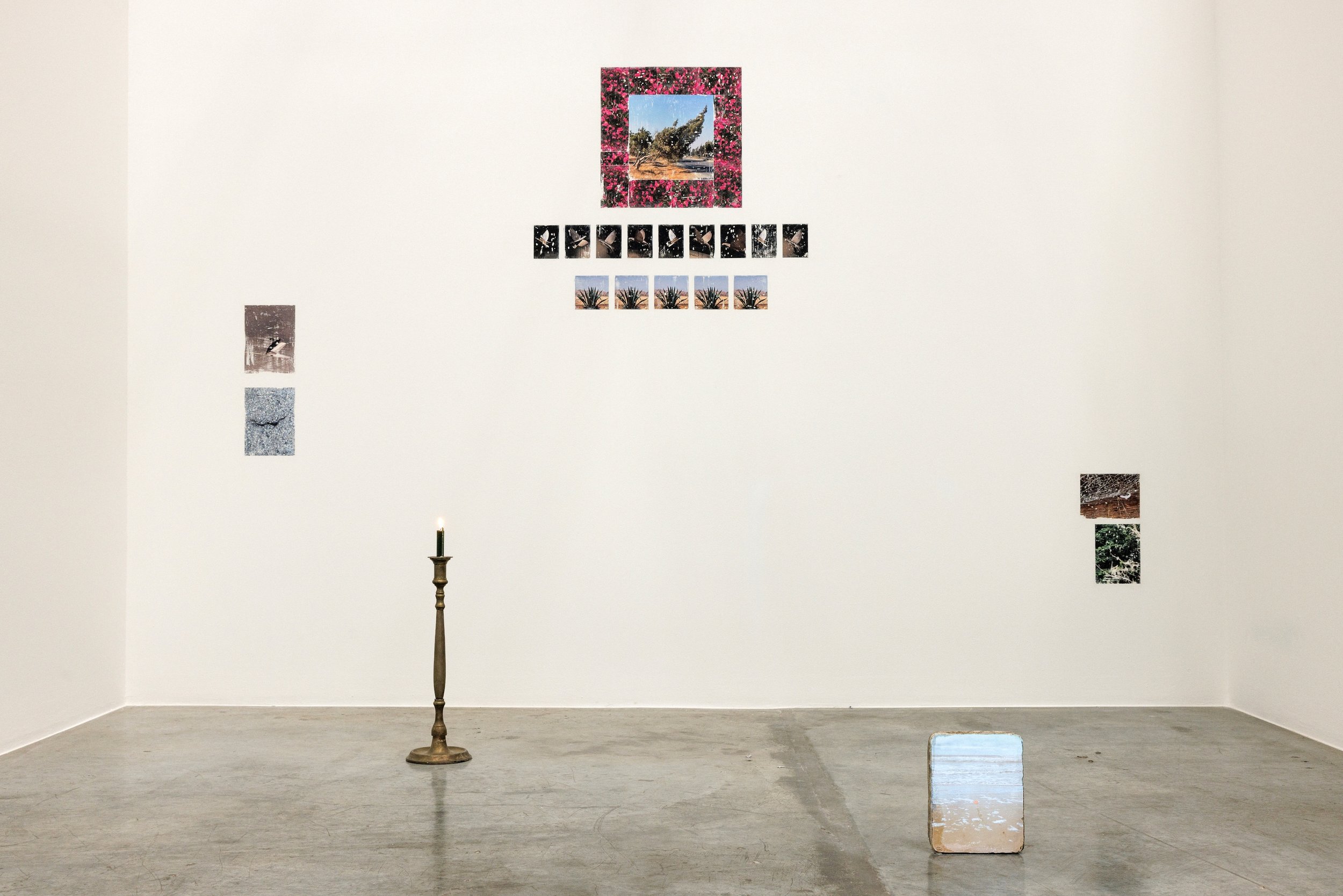  Voices from the cave, 2024, lithography stone, projector, image projection, candle stand, candle, laserjet print transfer on wall, dimensions variable 