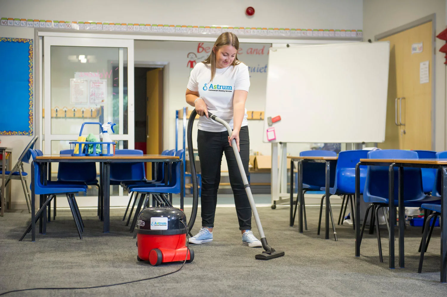 Astrum personnel vacuuming school carpets