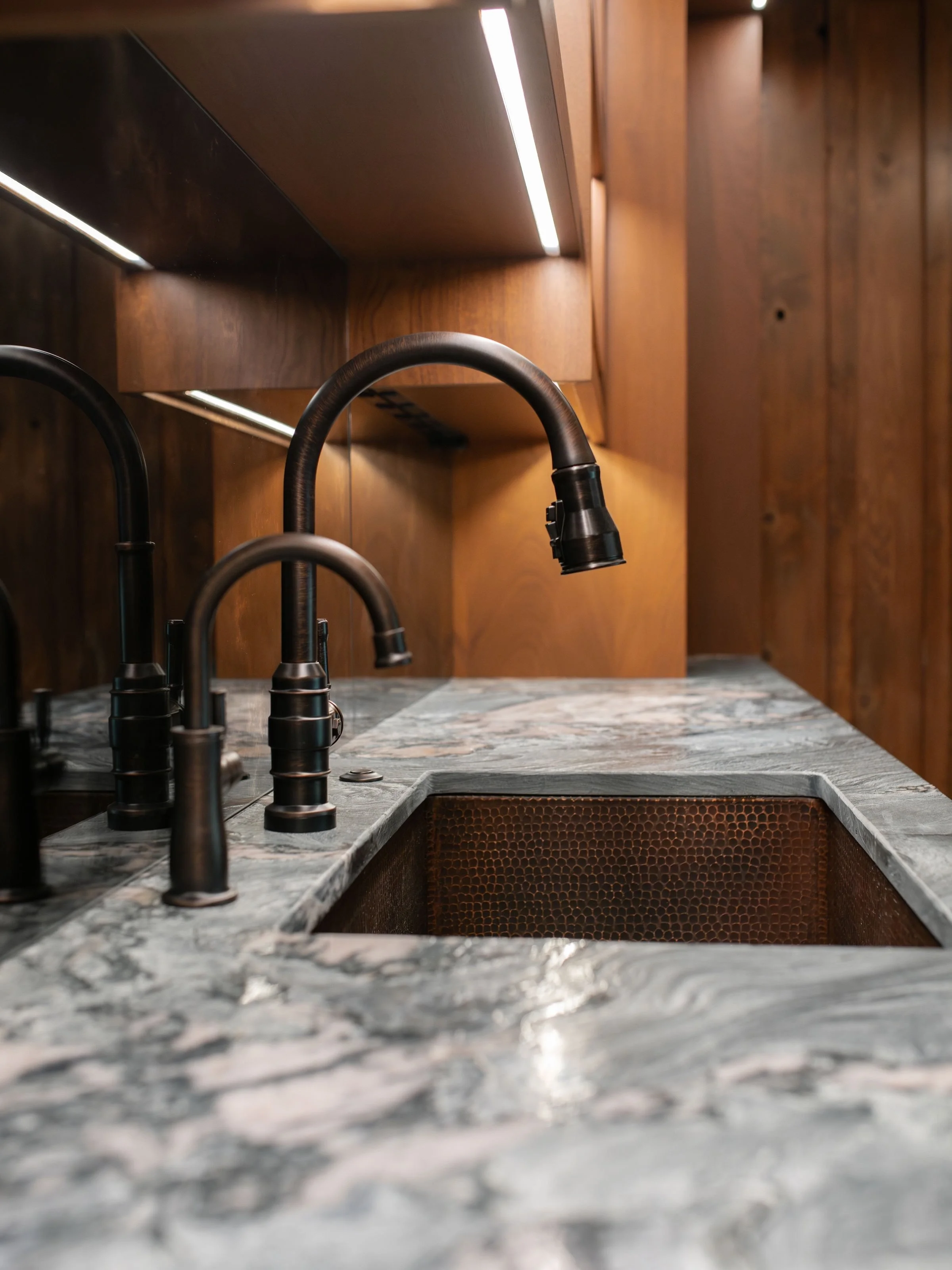 Take a closer look at the details in this moody basement recreation space in our award-winning Lakewood renovation + addition project 😍

This space highlights a built-in wet bar, integrated ice machine and plenty of storage making this the perfect s
