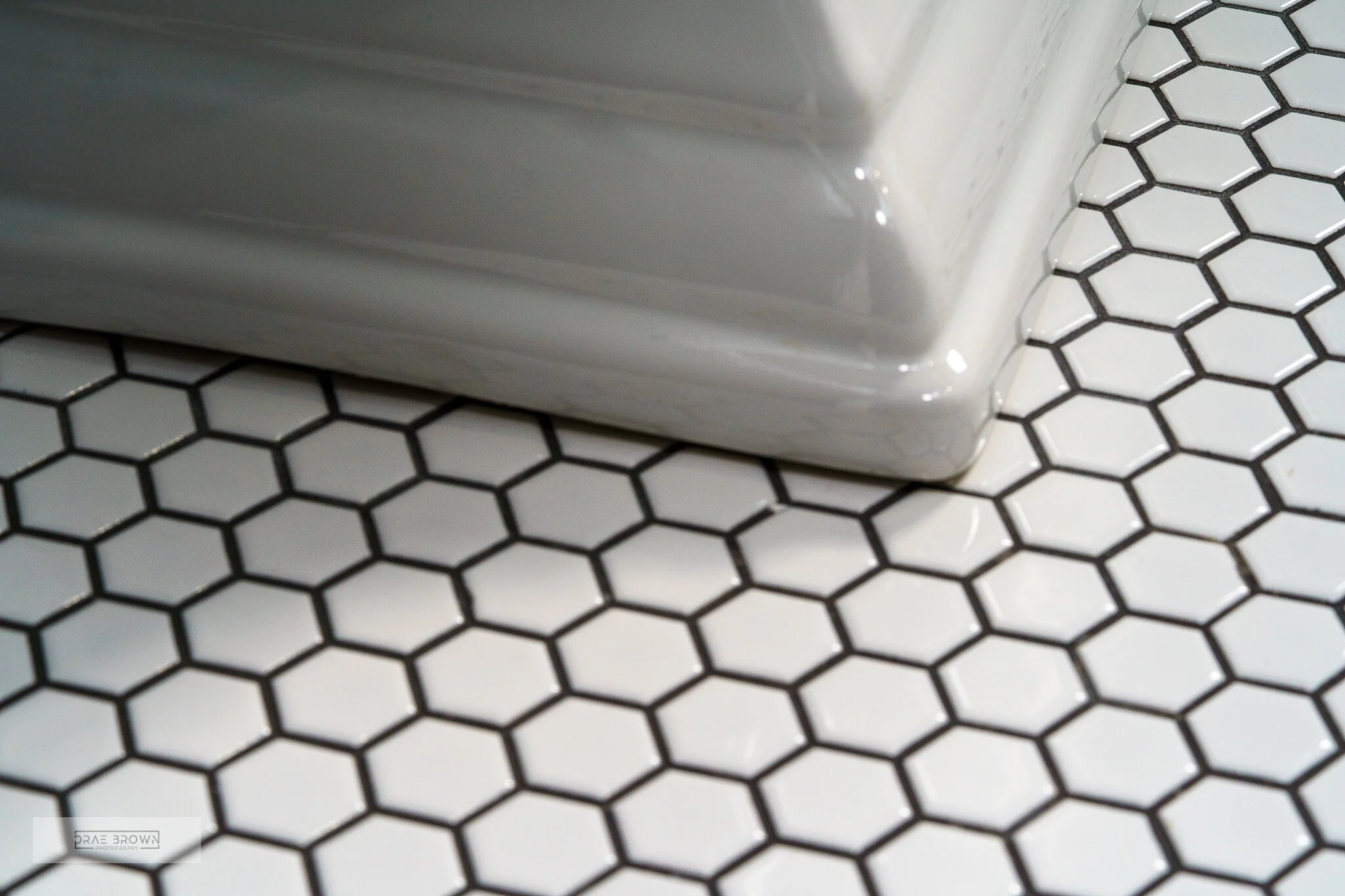 white hexagonal tile with black grout