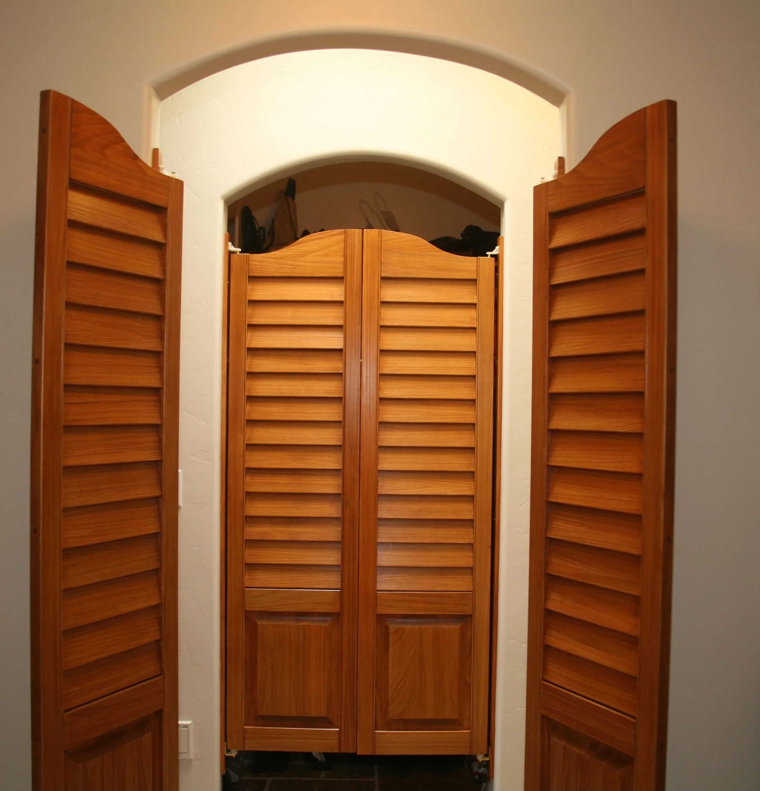 Swinging saloon-style doors provide ease of passage through each room while blocking them off in an aesthetically pleasing manner.