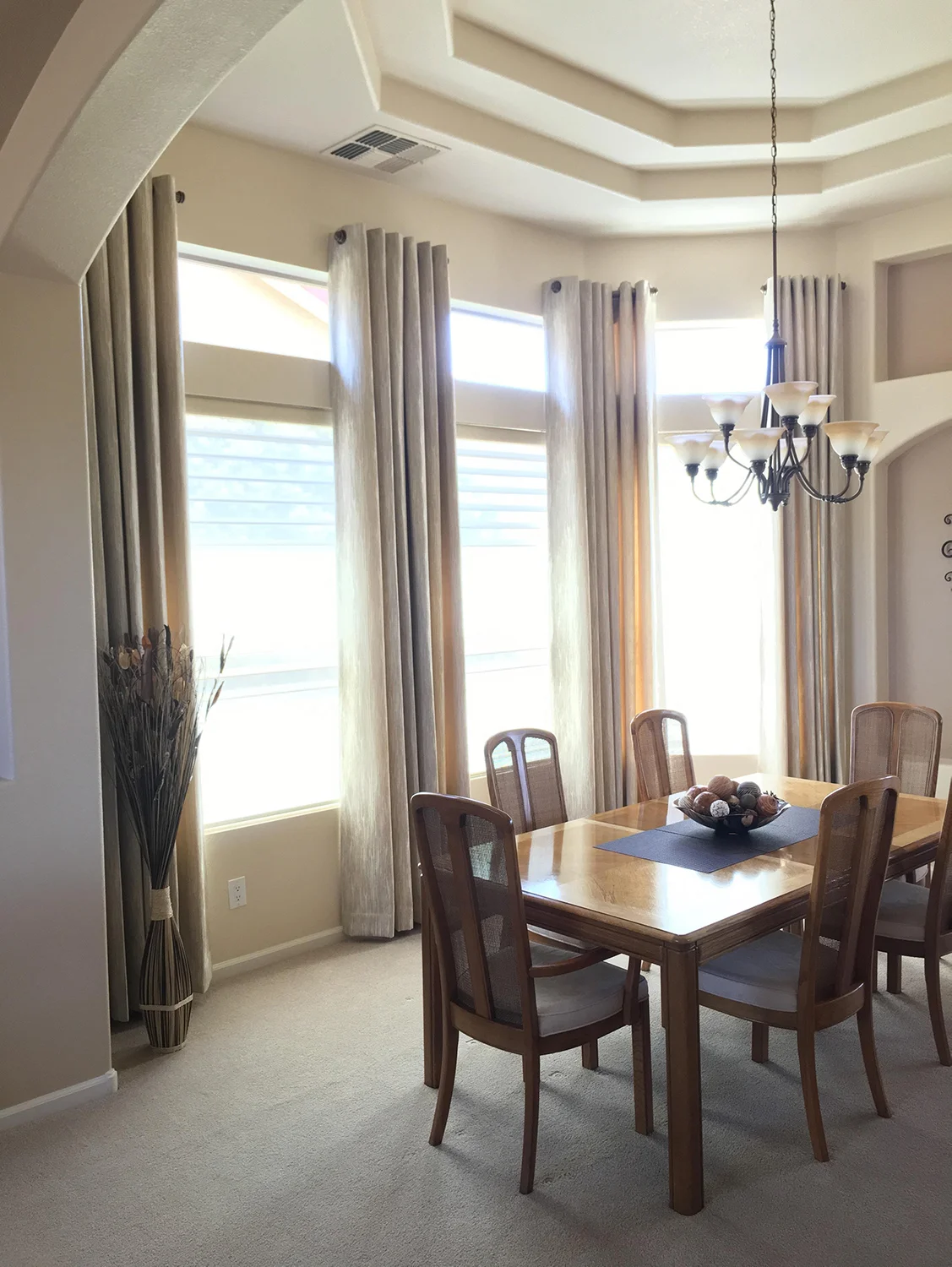 Here, we paired draperies with shades to match the color palette of this room.