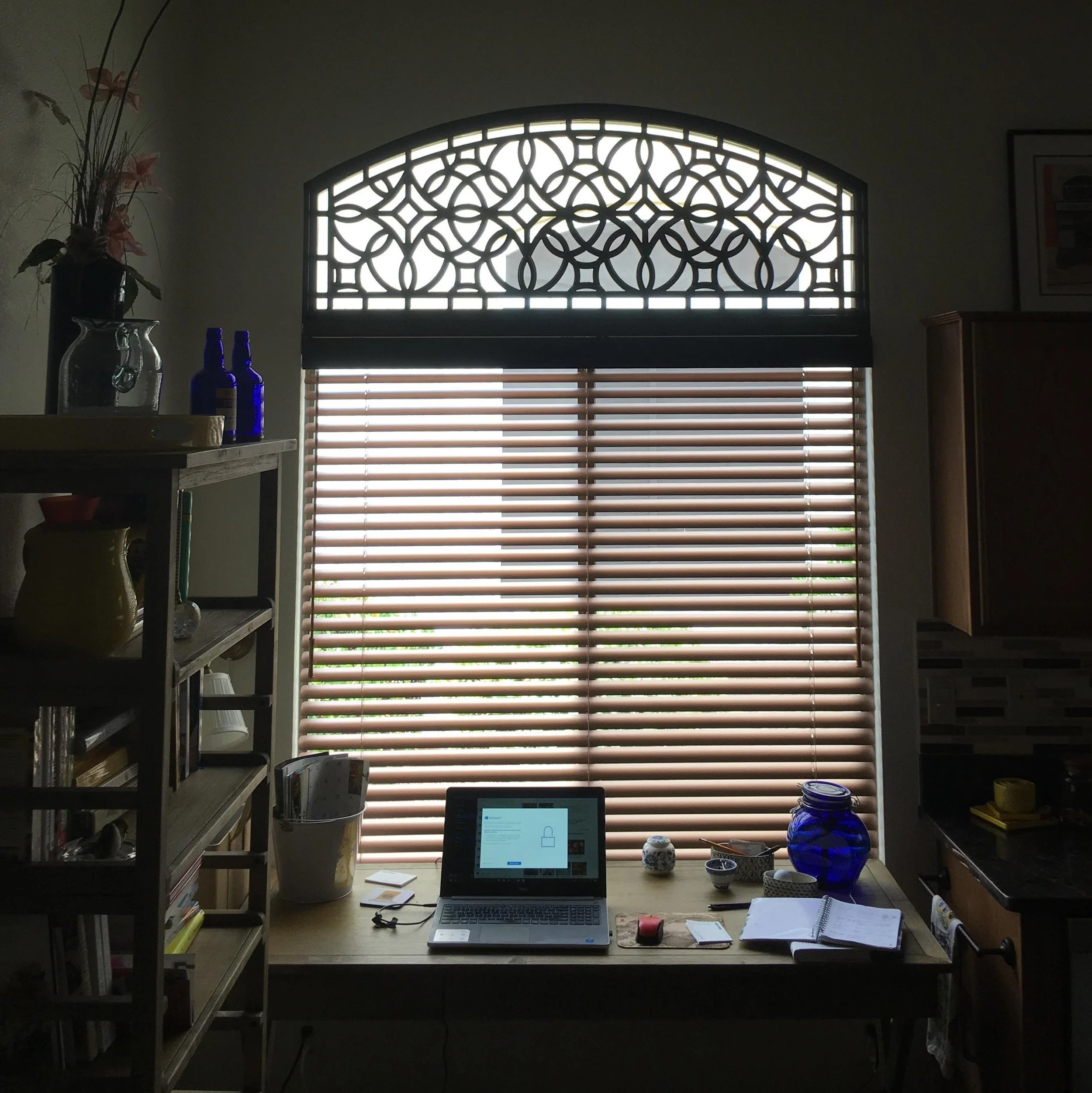 Blinds and a top treatment provide filtered light for this workstation.