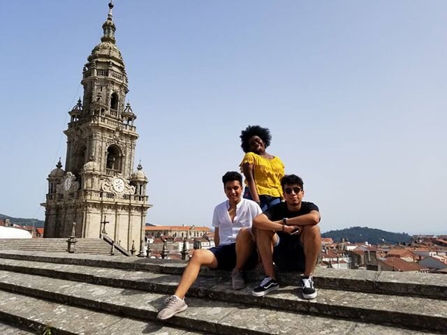  Carlos, Anisa, and Edgar from the Washington World Fellows program pose in front of European architecture in Spain. 