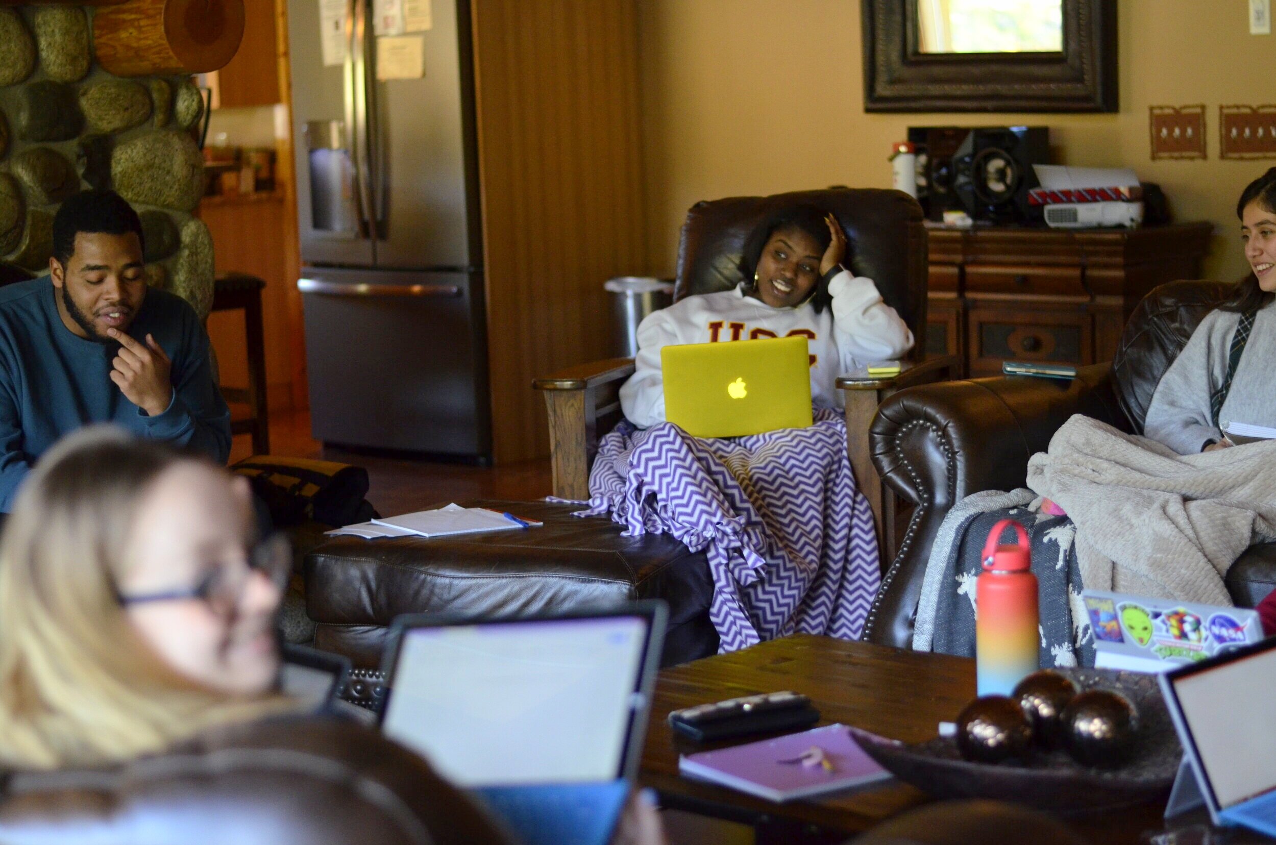  Anisa R. sits thinking while writing her personal statement during the Washington World Fellows program college prep Writing Weekend.  