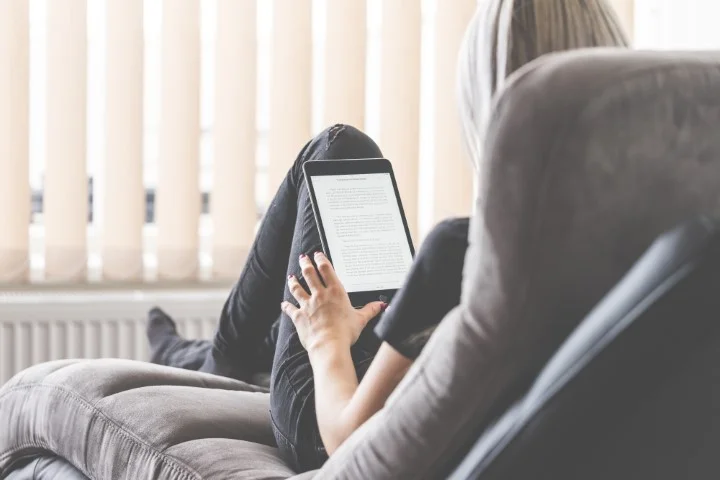 young-woman-reading-ebooks-on-her-ipad-tablet-picjumbo-com (Small).jpg