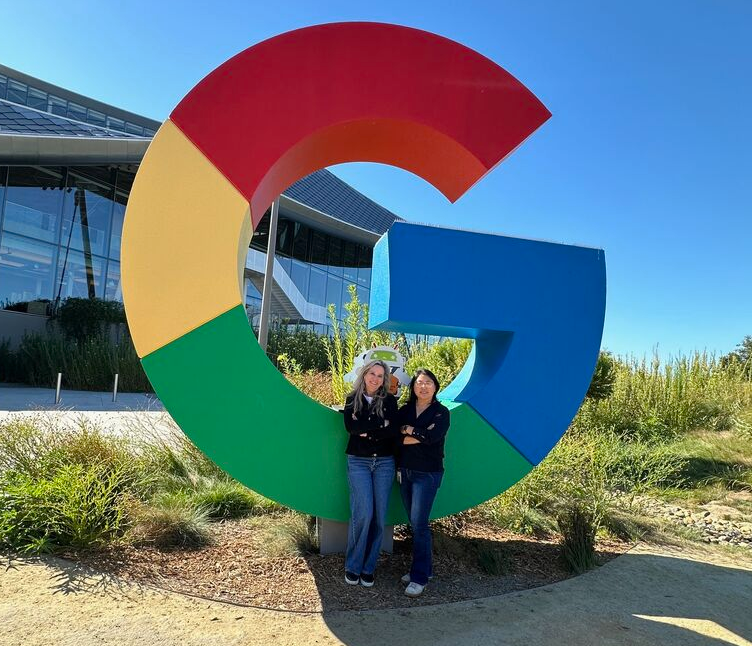 Yvette posing in front of Google "G"