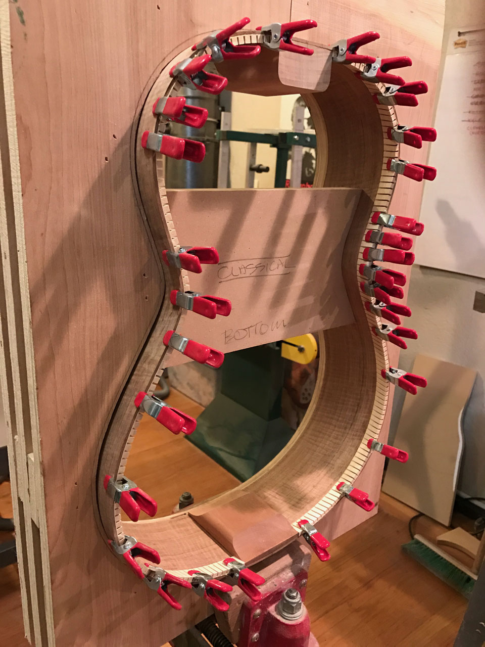 THE CLASSICAL "HOOP" IS HAVING ITS LINING STRIPS GLUED INTO PLACE. THESE PROVIDE A SURFACE ONTO WHICH THE TOP AND BACK ARE GLUED.