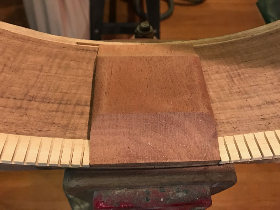 IN THE CLASSICAL GUITAR, THE HEEL BLOCK IS CUT BACK FROM TOP AND BACK TO ALLOW THE ENTIRE SURFACE TO VIBRATE AS ONE PIECE.