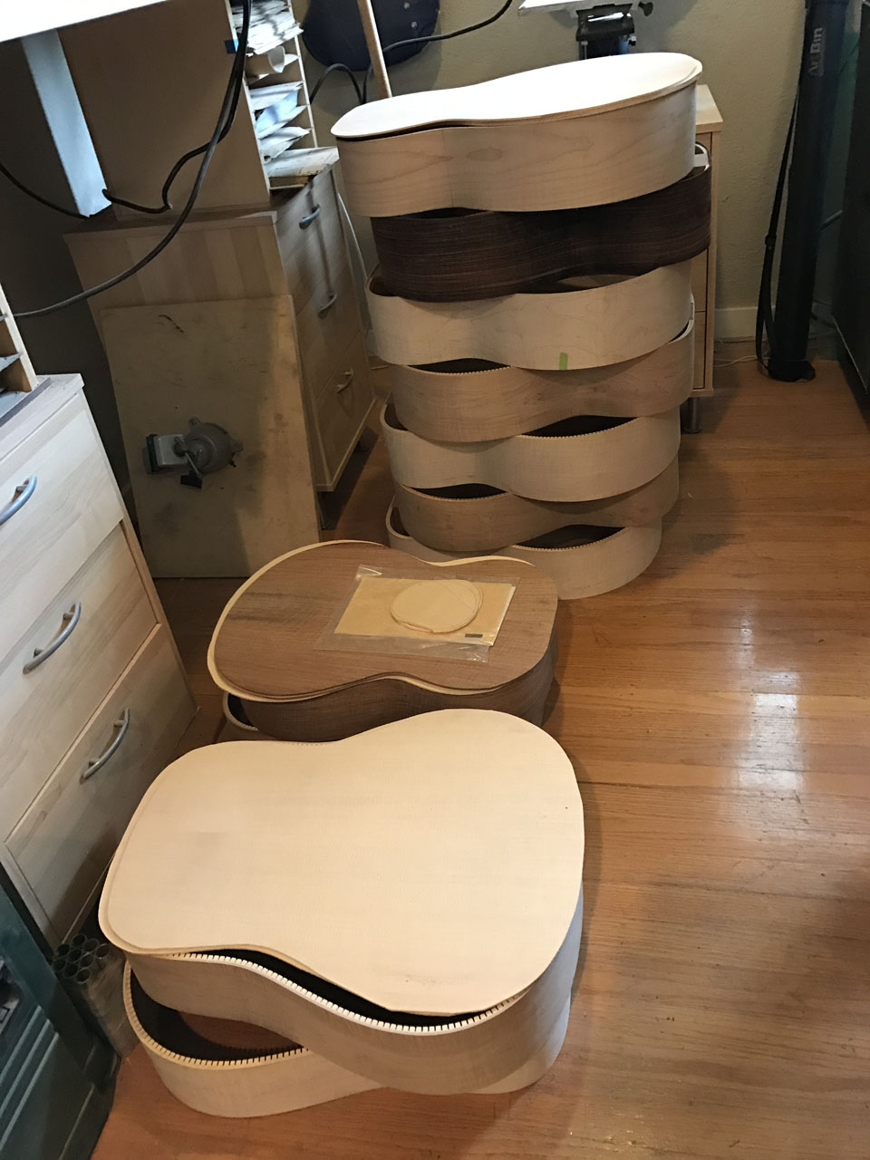 STACKS IN THE WORKSHOP OF BODY "HOOPS", TOPS, AND BACKS, WAITING THEIR TURN TO BE ASSEMBLED INTO COMPLETED BODIES, TERMED "BOXES".