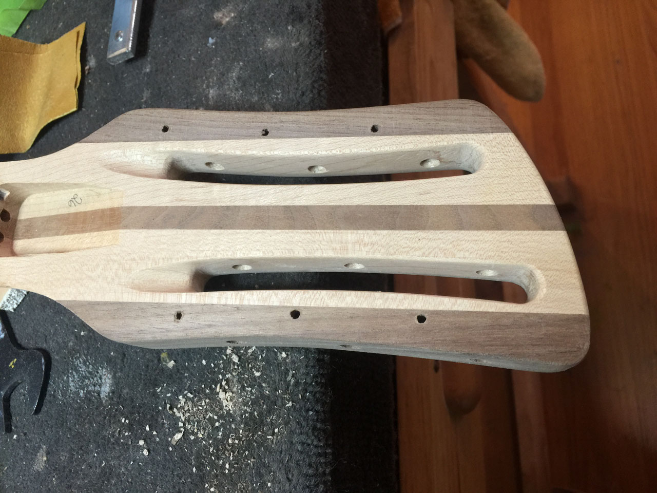 THIS 12-STRING HEADSTOCK HAS BEEN FINAL-SHAPED, AND IS READY TO HAVE ITS TUNER HOLES DRILLED AND COUNTERBORED. PLACEMENT OF THESE IS CRITICAL, OR ADJACENT TUNING KEYS MAY INTERFERE WITH EACH OTHER.